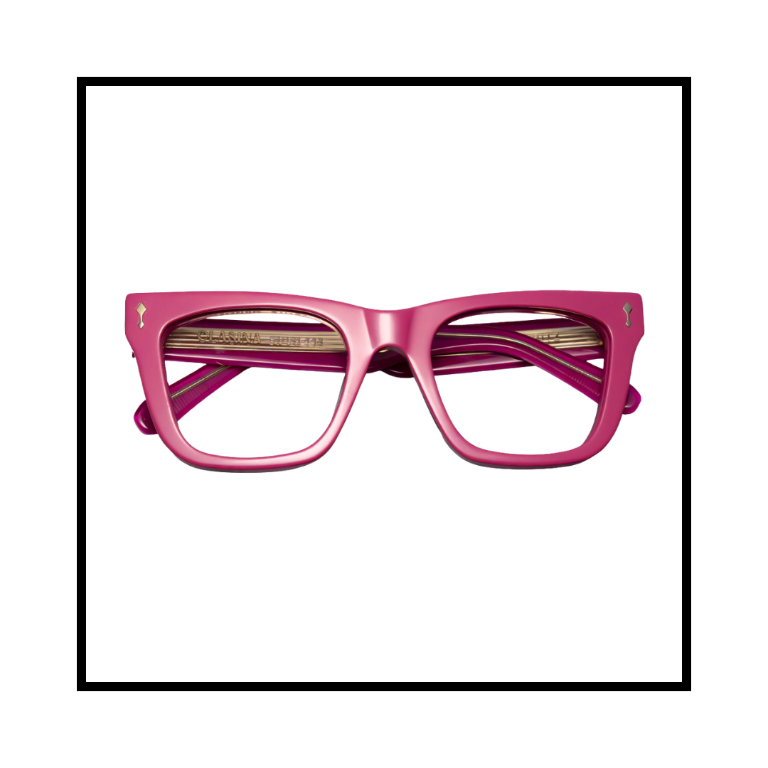 Pink eyeglasses with thick frames and gold accents on the temples and a decorative detail on the corners.