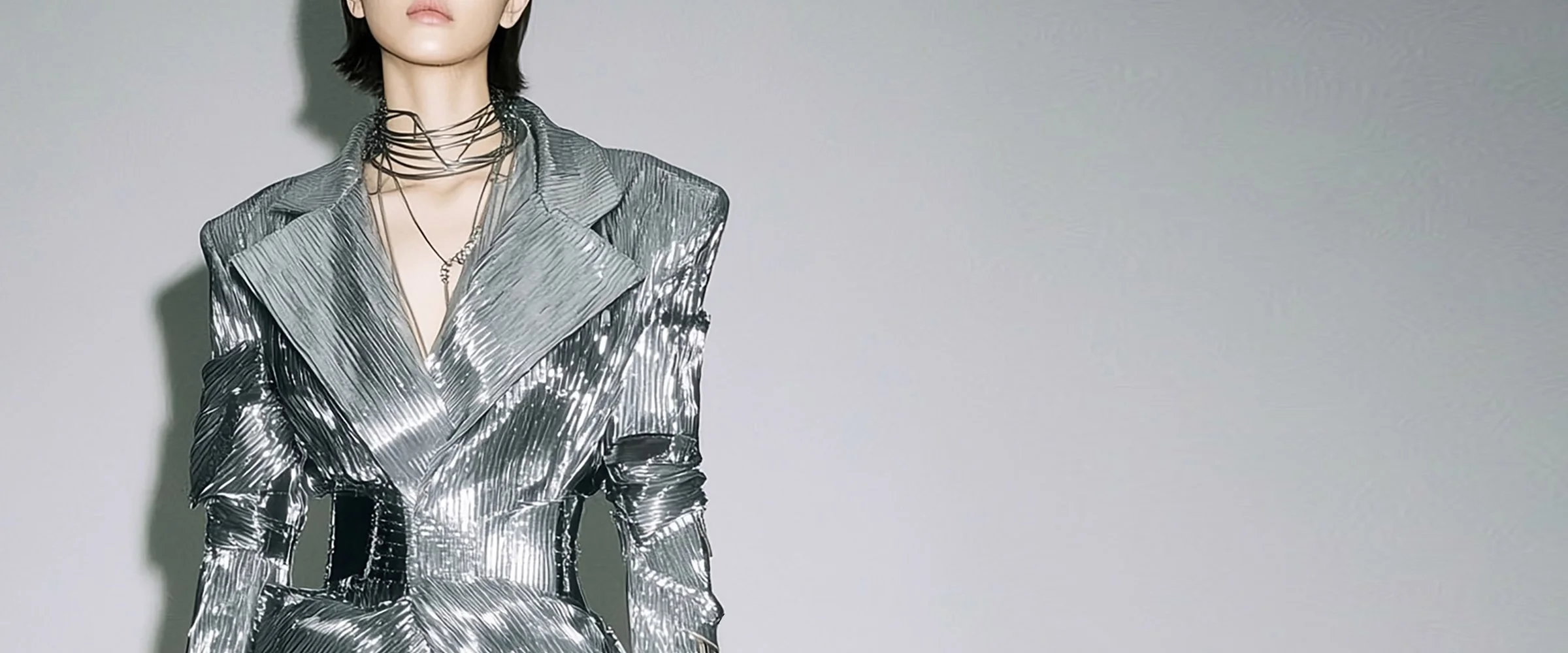 Model and brand ambassador Jun Xeda in a striking silver embellished textured dress with matching heels. The outfit is otherworldly and resembles an interstellar stream, designed by digital fashion brand [ze Luna] for the [Offworld] collection.