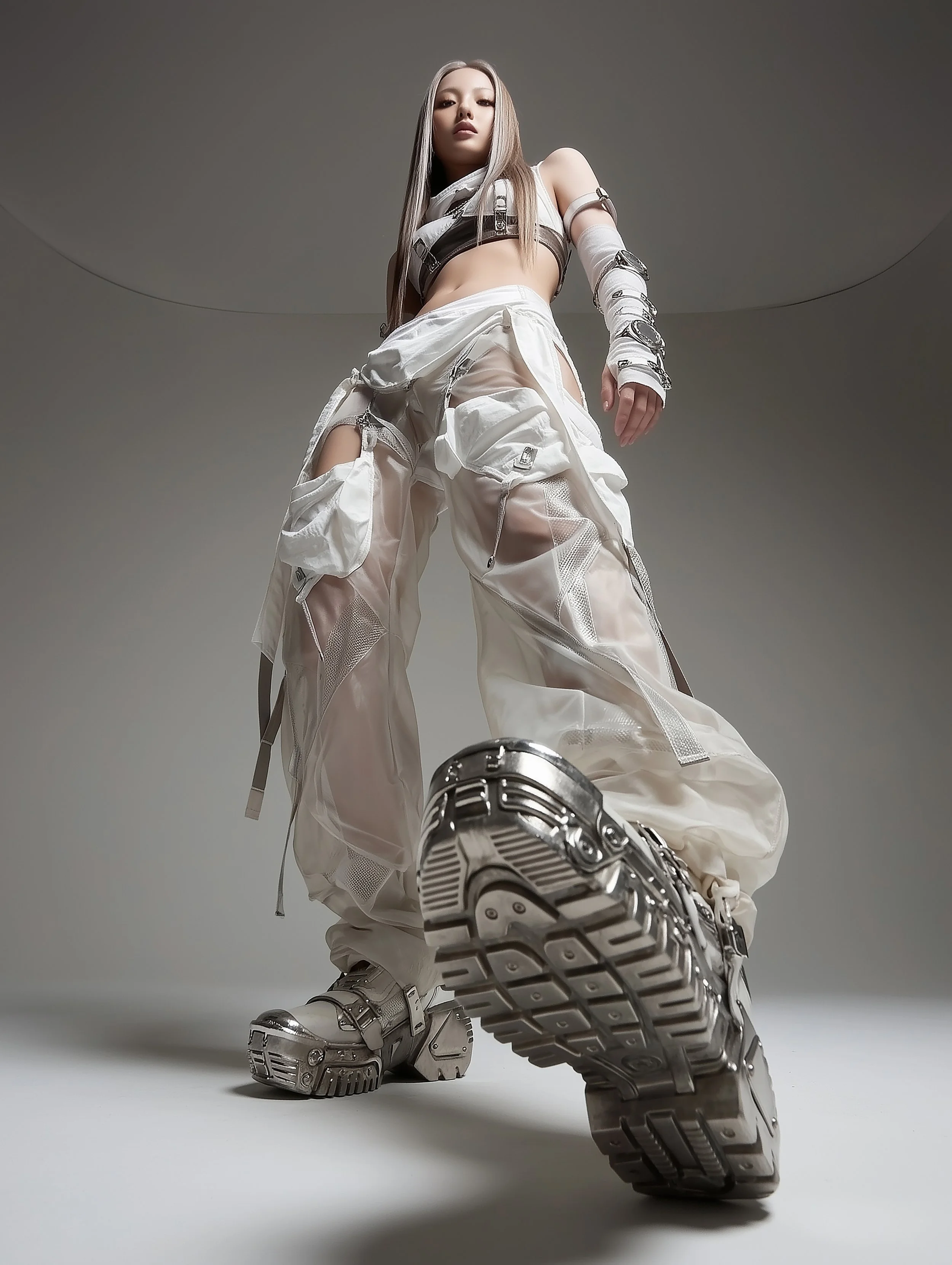 A model posing boldly and confidently, wearing an avant-garde experimental streetwear styled fashion that consists of white layered fabric, chrome inserts and a pair of chrome boots, designed by digital fashion brand [ze Luna].