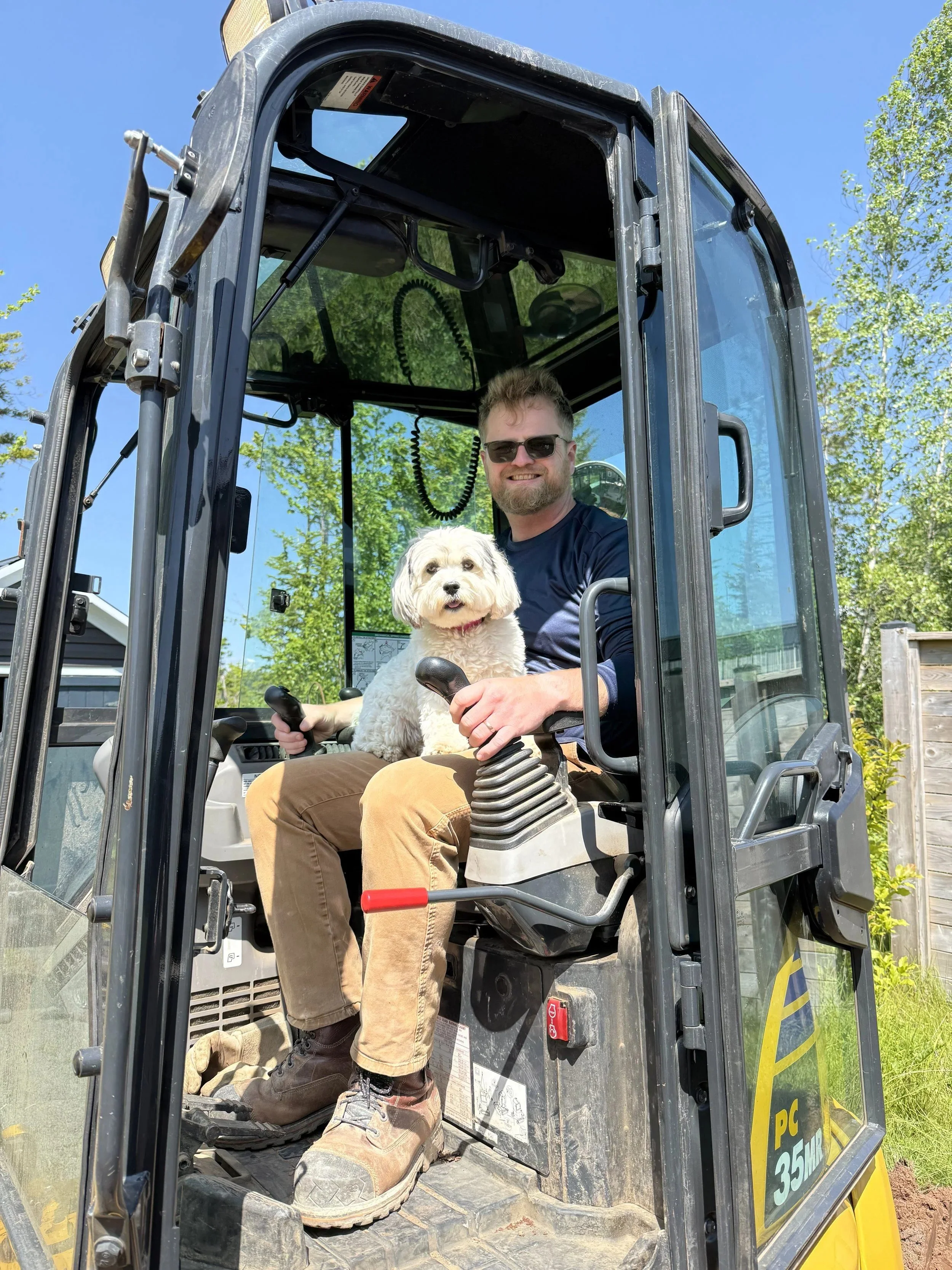 Madison Byrnes seated in an excavator on a job site