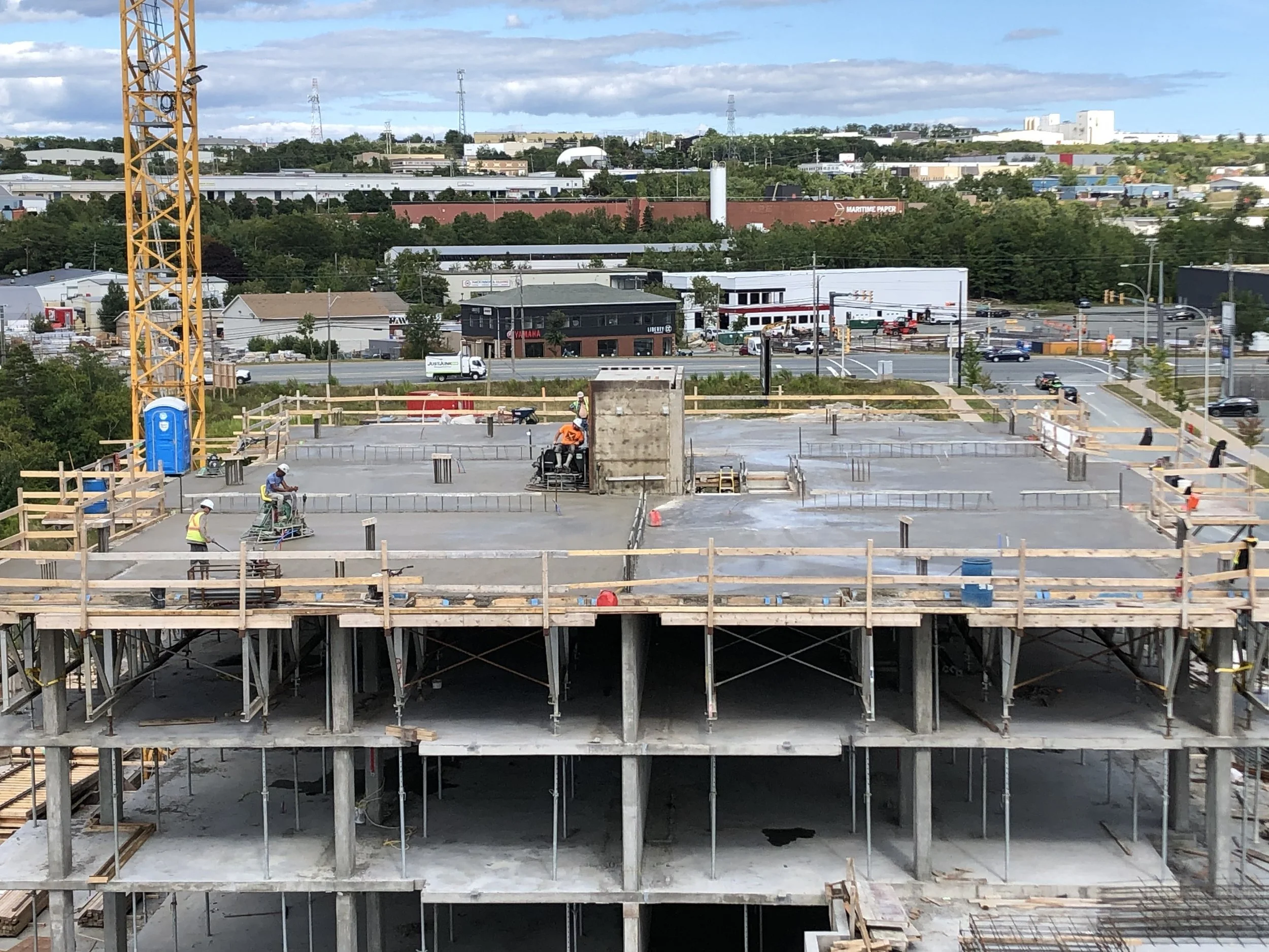 Concrete structure with cranes under construction at a residential development site