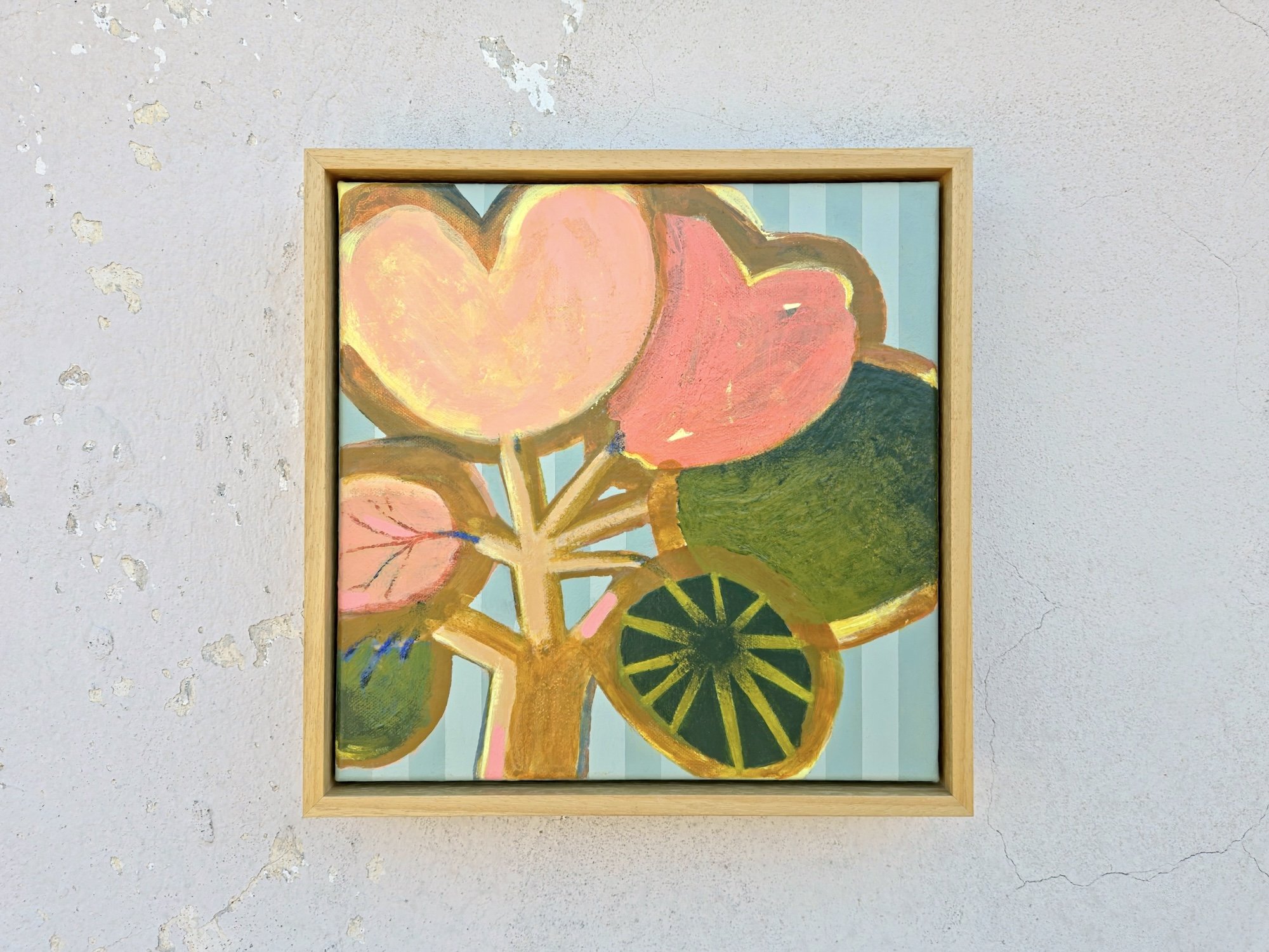 framed botanical painting in bright pinks and greens on a striped background