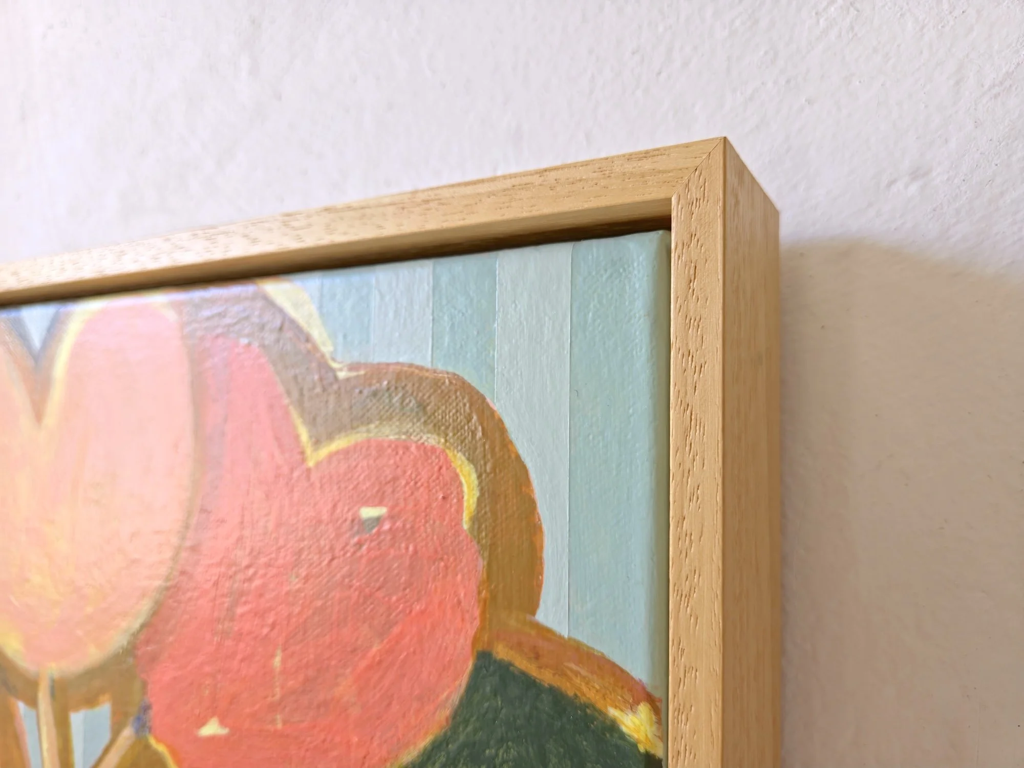 detail of botanical painting in bright pinks and greens on a striped background