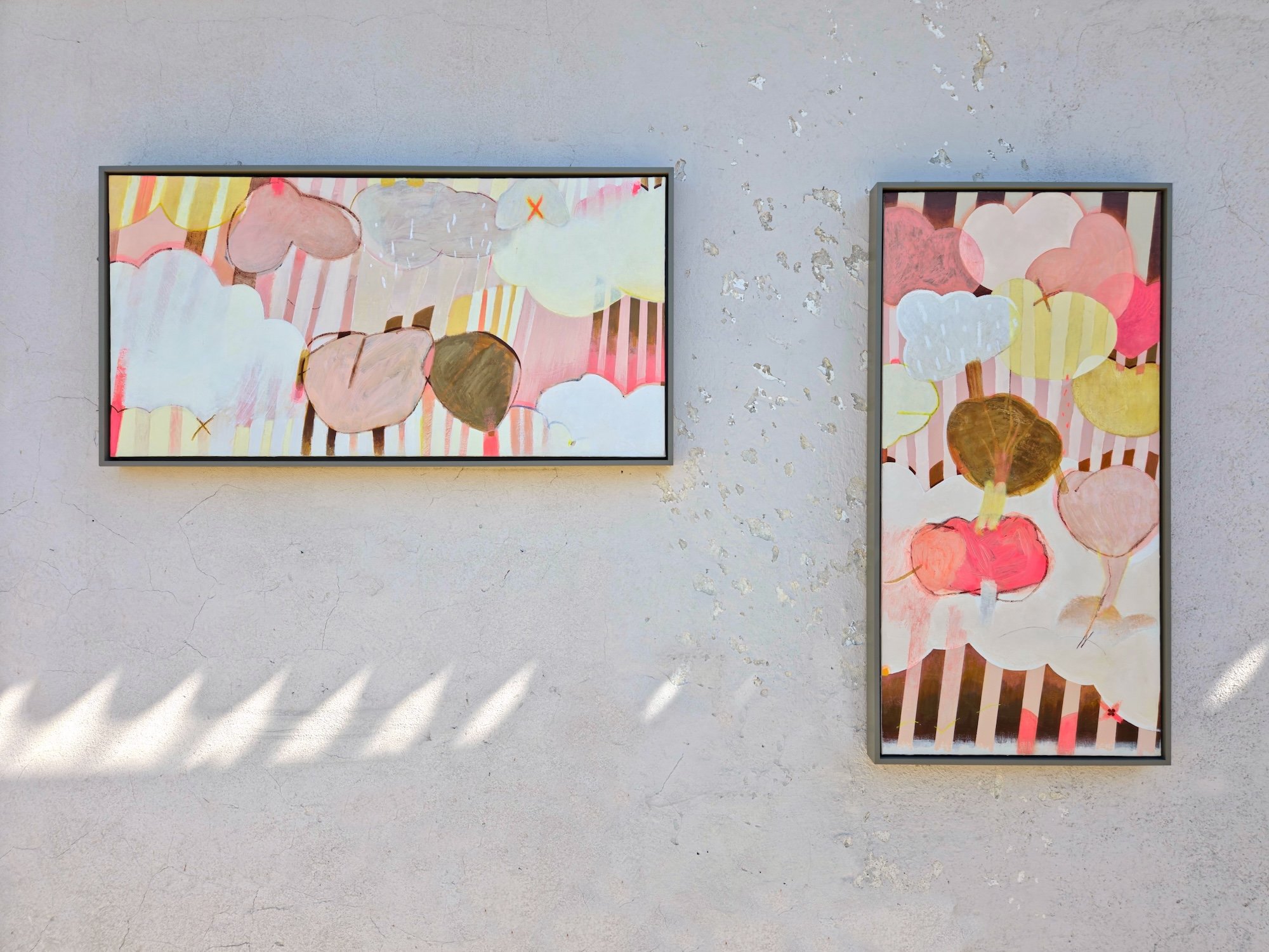 two framed botanical paintings in pinks and browns with bold stripes