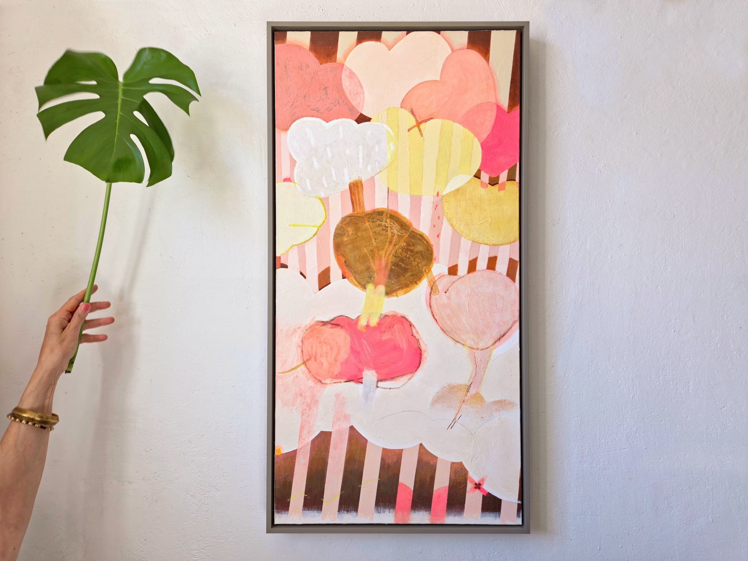 framed botanical painting in pinks and browns with bold stripes