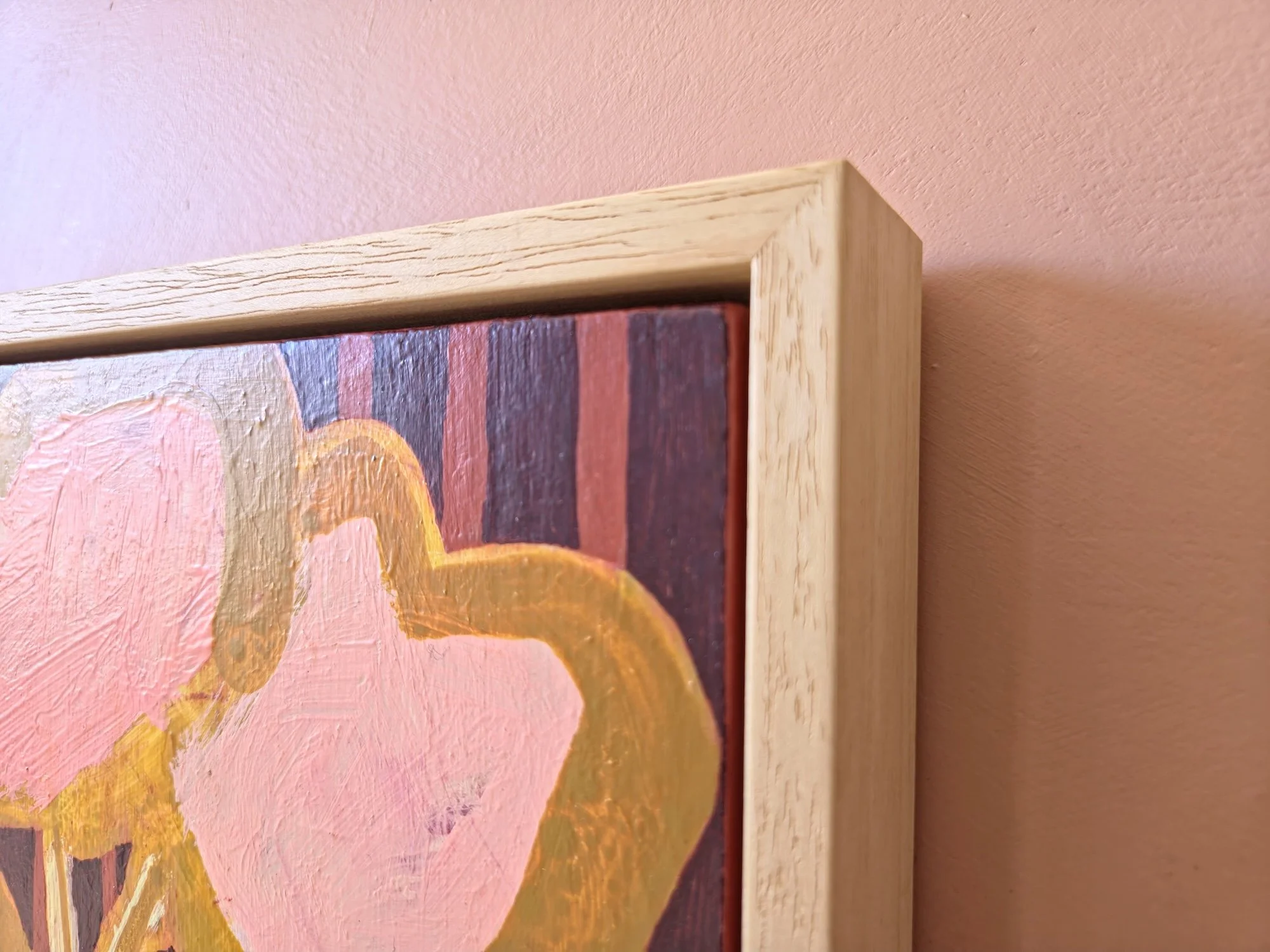 detail of framed botanical painting in pinks and browns