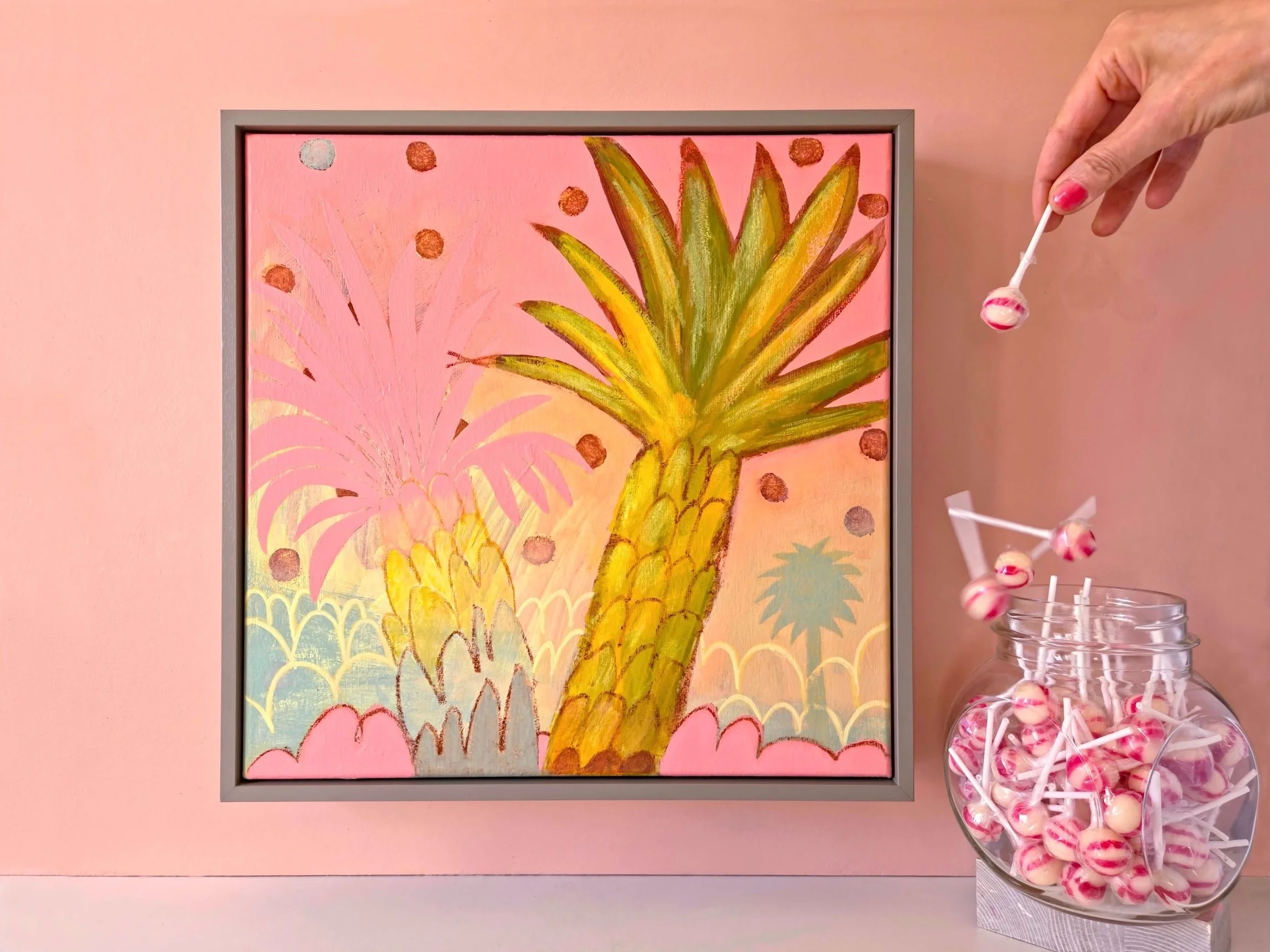 framed palm tree painting on a vibrant pink background hanged on a pink wall