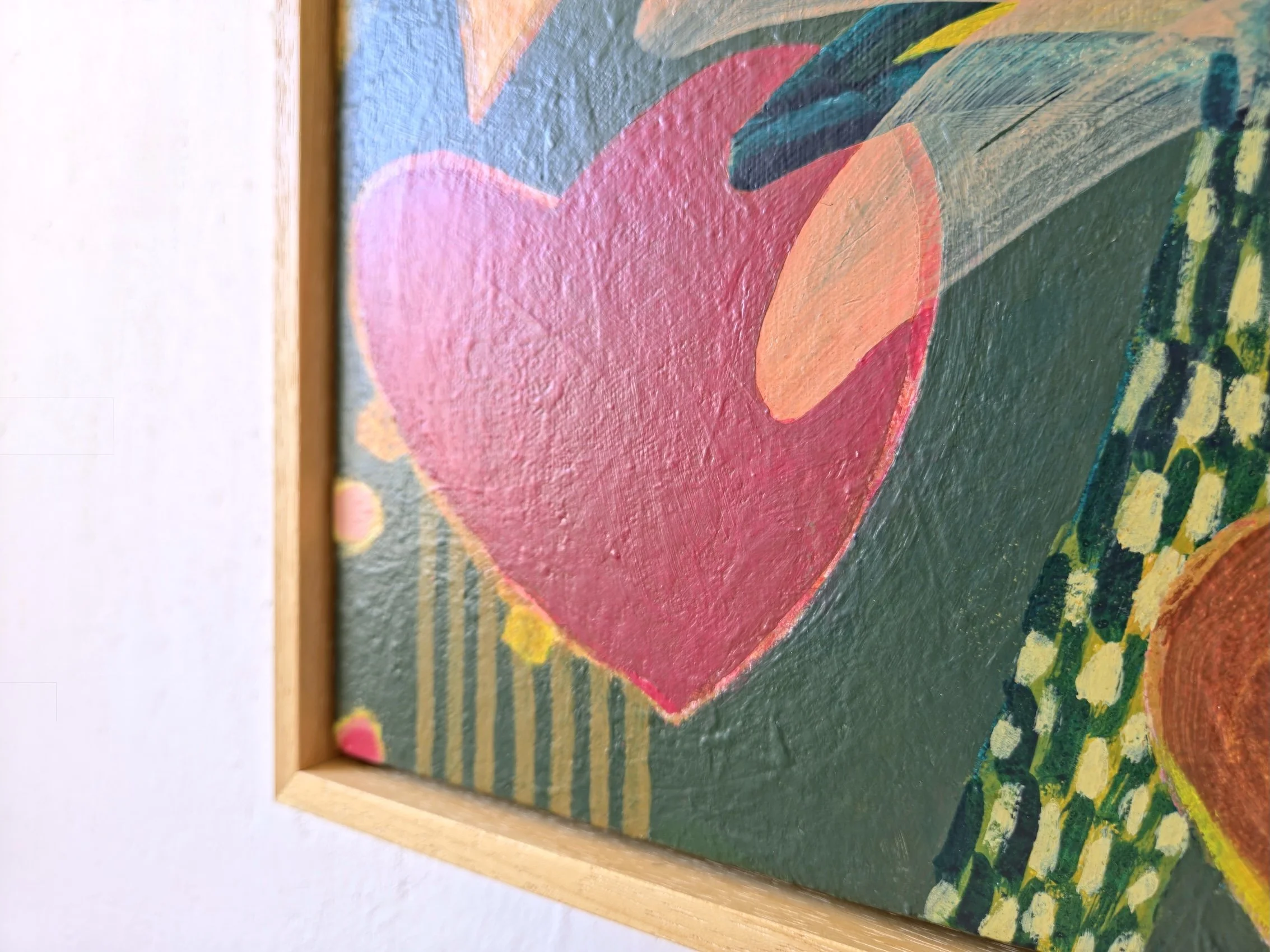 detail of framed botanical painting in red, browns and greens