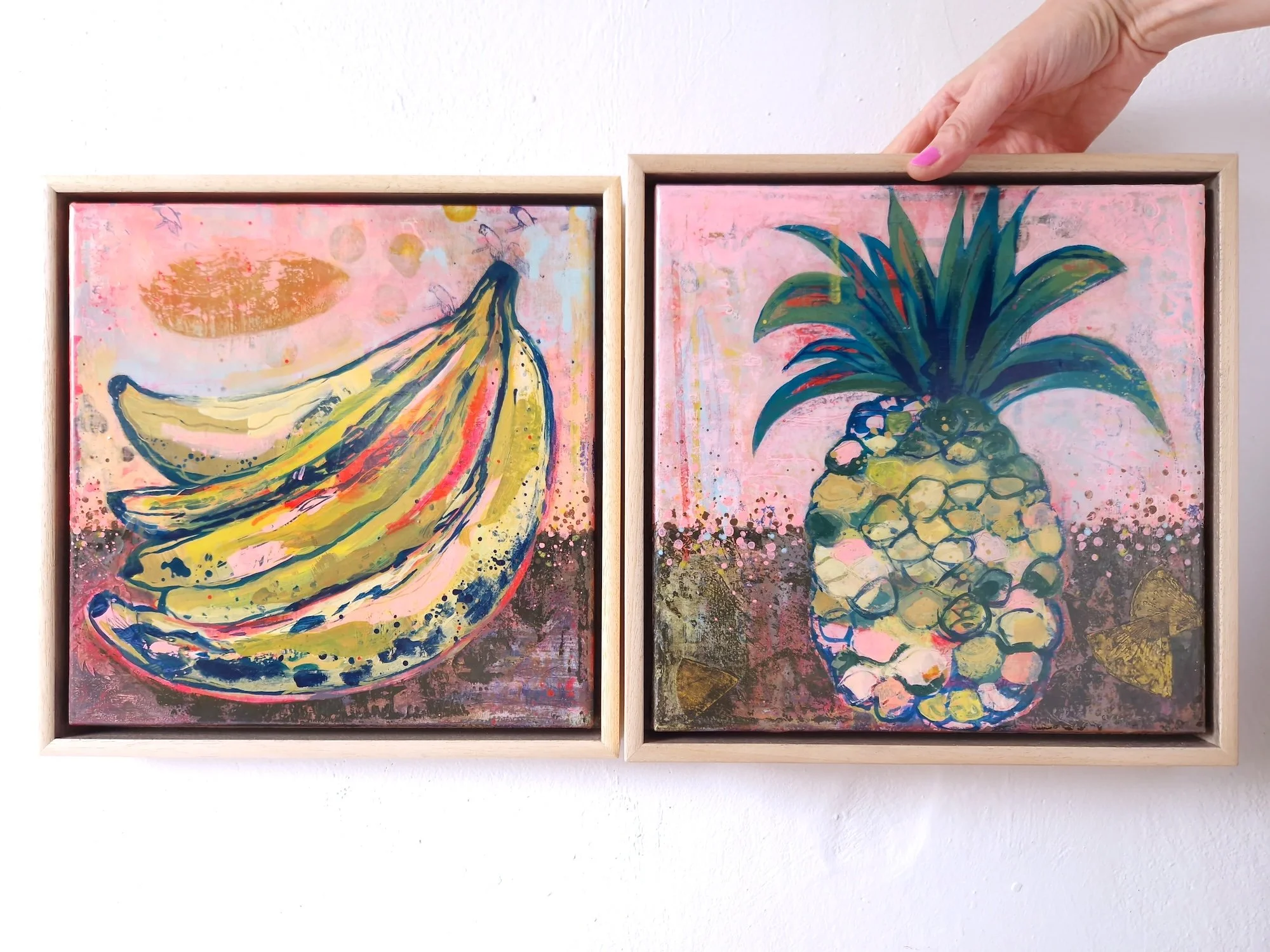 colourful abstract paintings of vibrant bananas and ananas, framed