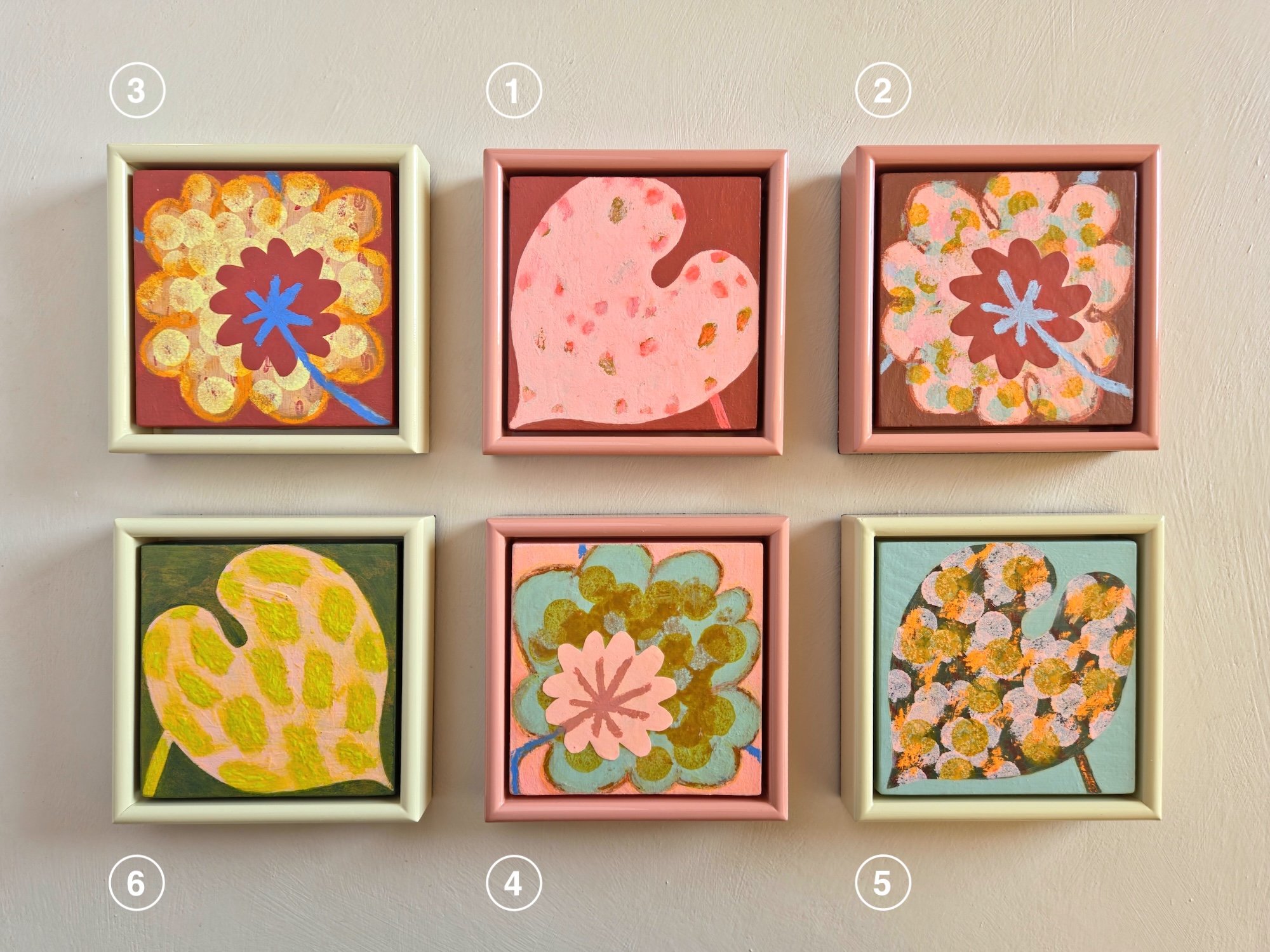 six small framed botanical paintings on a beige background