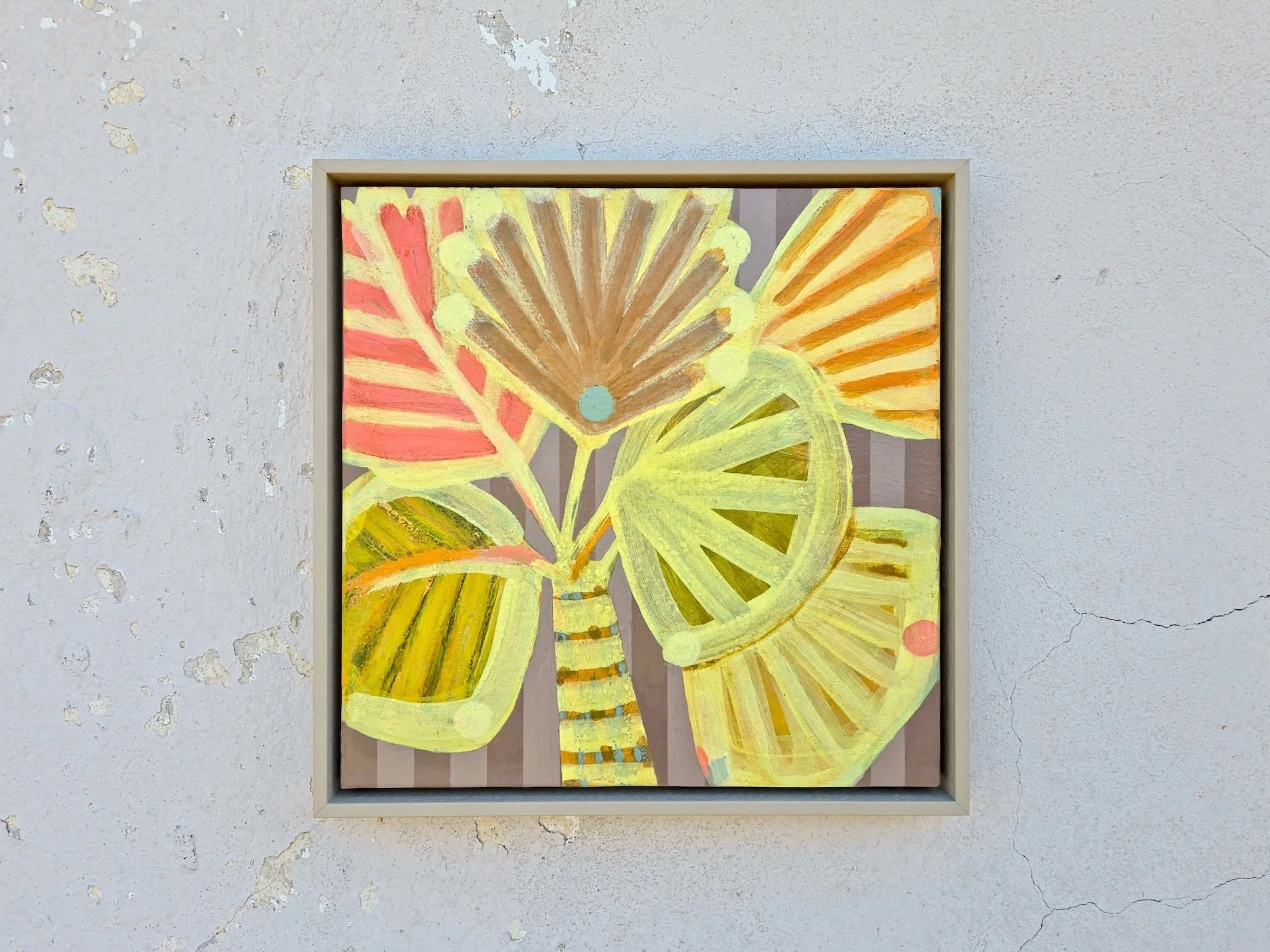 framed palm tree painting in bright yellows and pinks