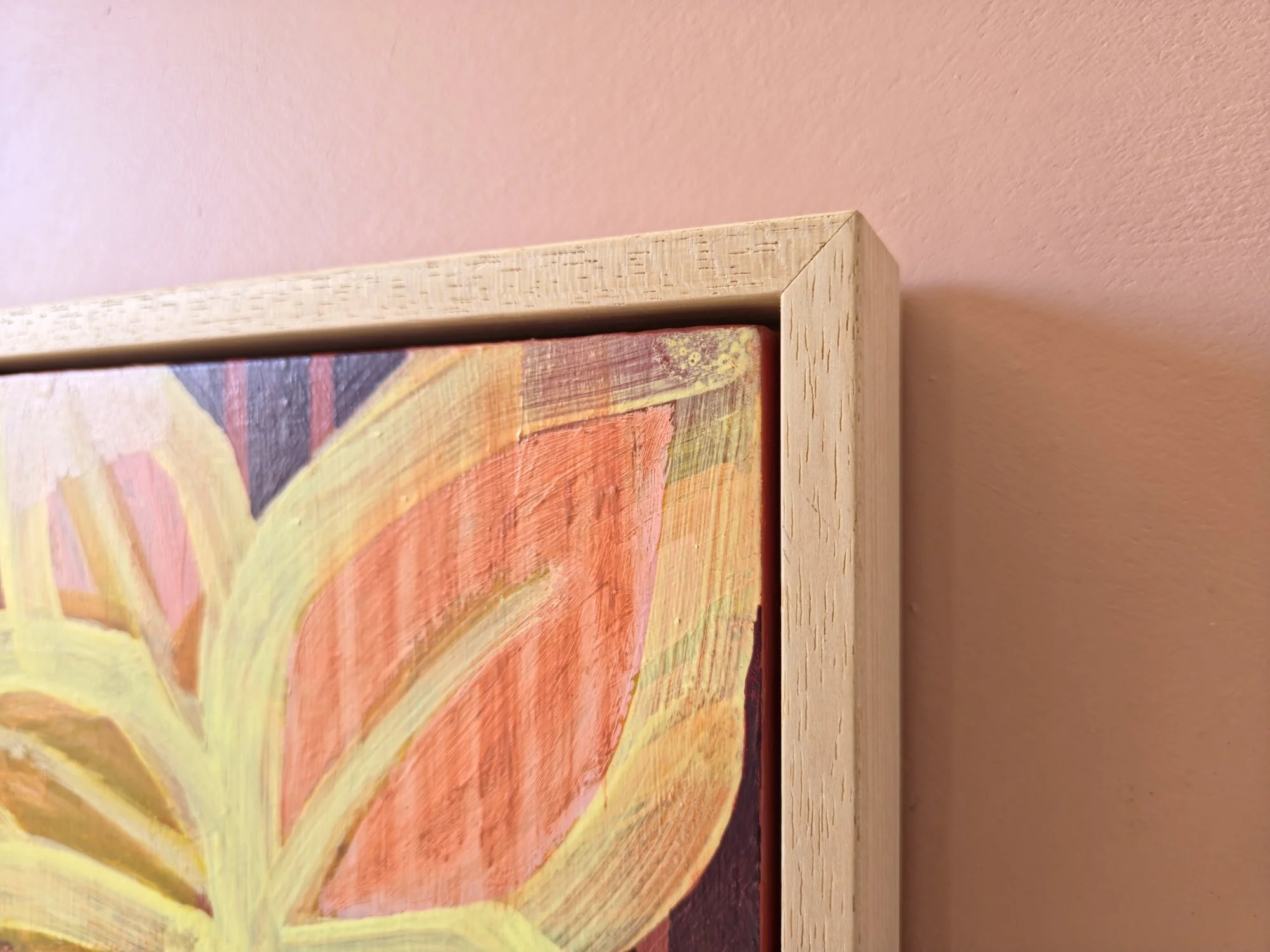detail of framed botanical painting in pinks, yellows and browns