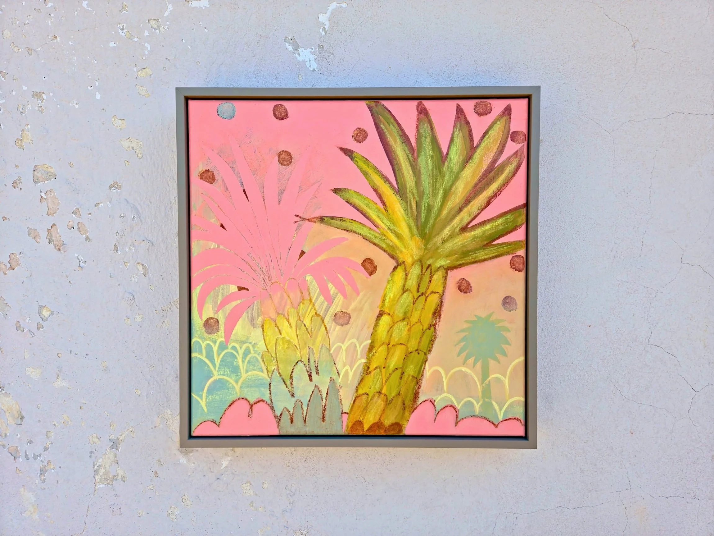 framed palm tree painting on a vibrant pink background