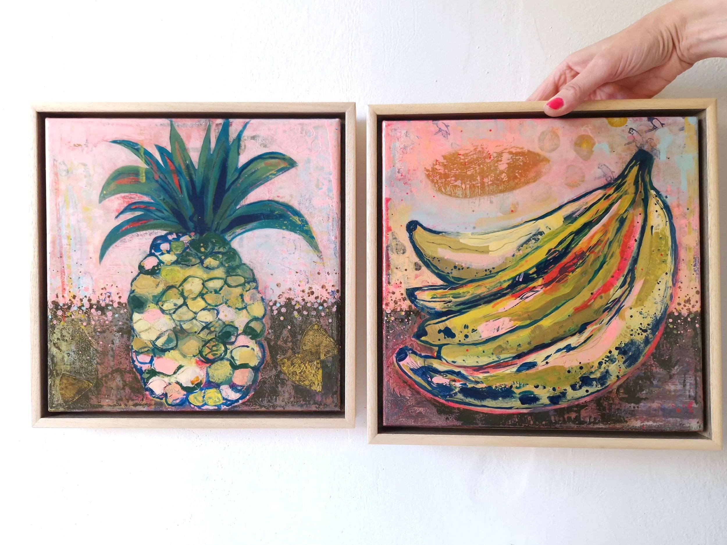 cheerful abstract paintings of a colourful pineapple and bananas, framed