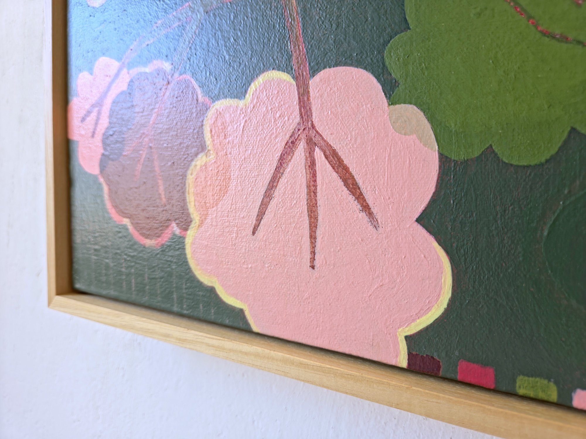 detail of framed botanical painting in pinks and greens