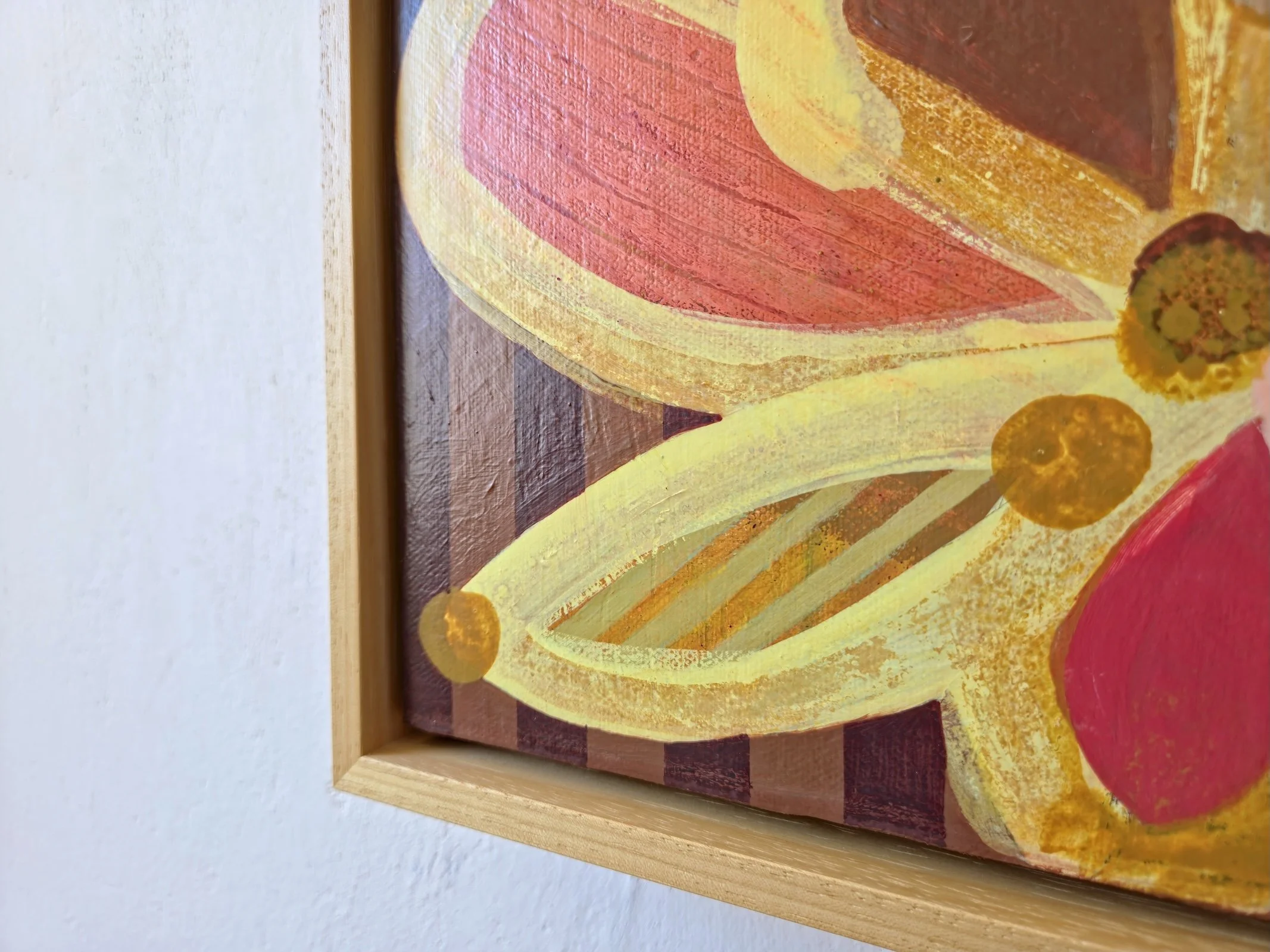 framed botanical painting in yellows and pinks on a striped background, detail