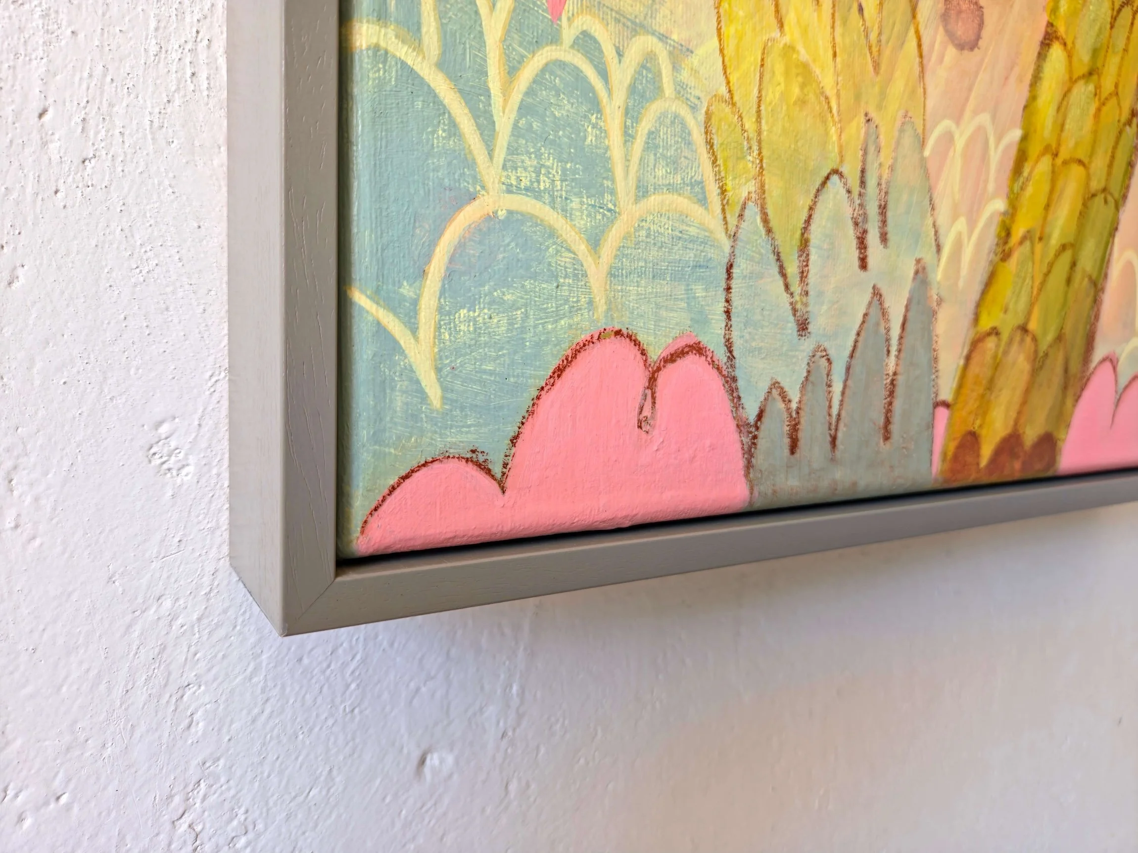 detail of framed palm tree painting on a vibrant pink background