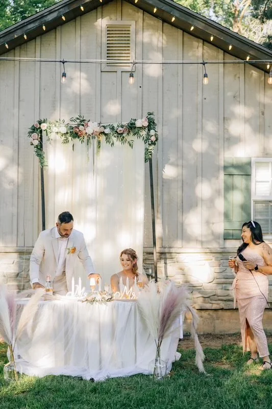 Sweetheart table set beside Old Town Hall at an outdoor Huntsville wedding