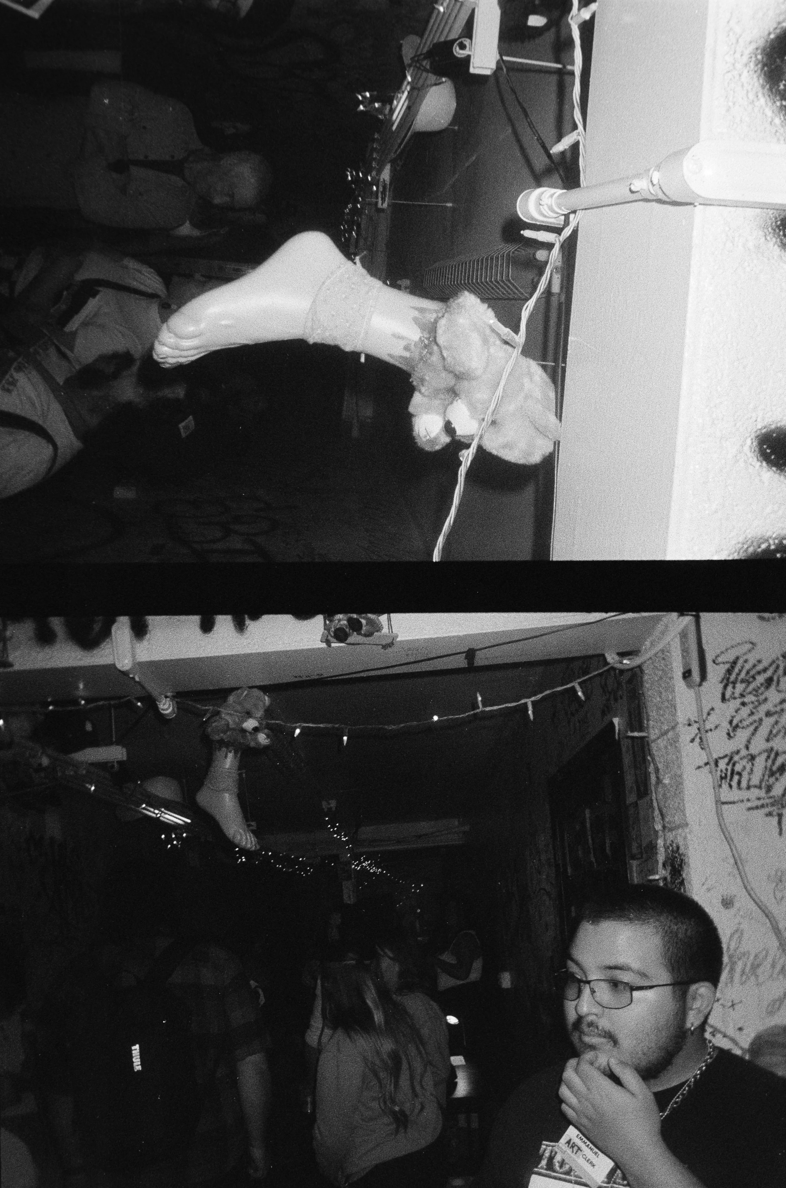 Black and white photo of a party scene, with balloons, string lights and people gathered in a dimly lit space. Opening for Collective.Objective