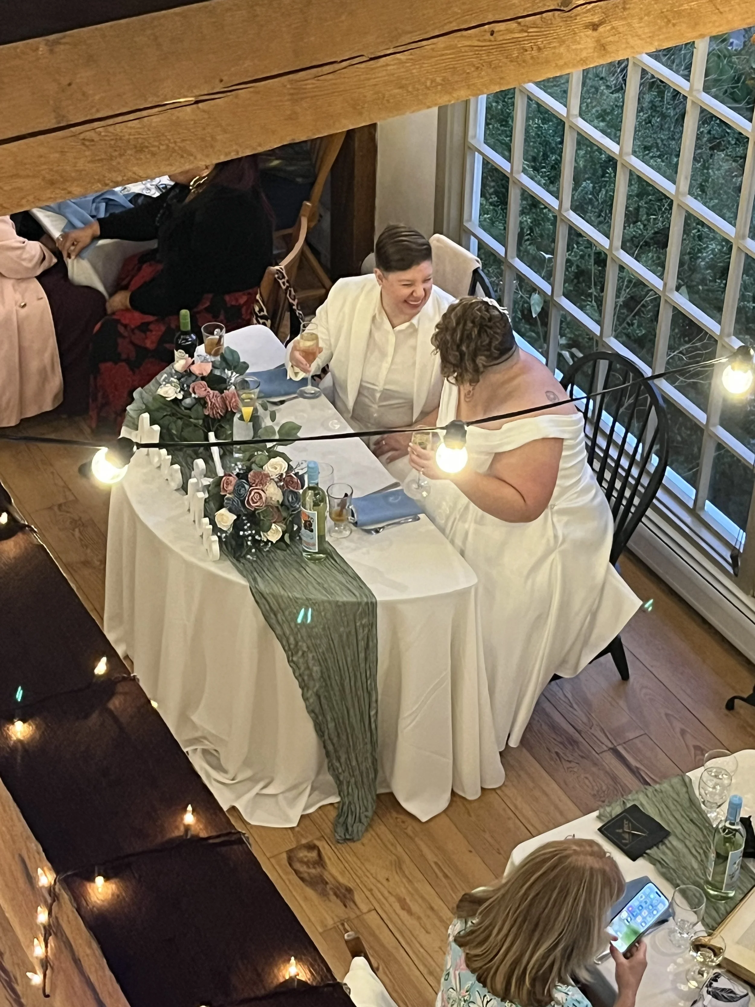 Newlyweds Arielle and Amber enjoying a celebratory glass of champaign at their reception at Bittersweet Farm in Westport MA