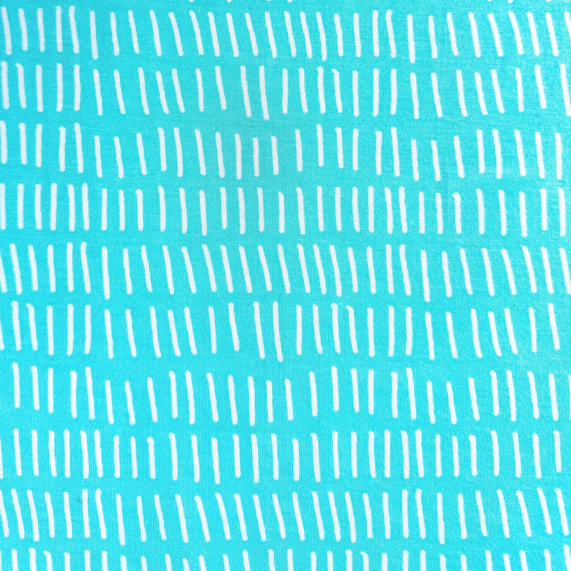Close-up of turquoise fabric with white vertical lines.