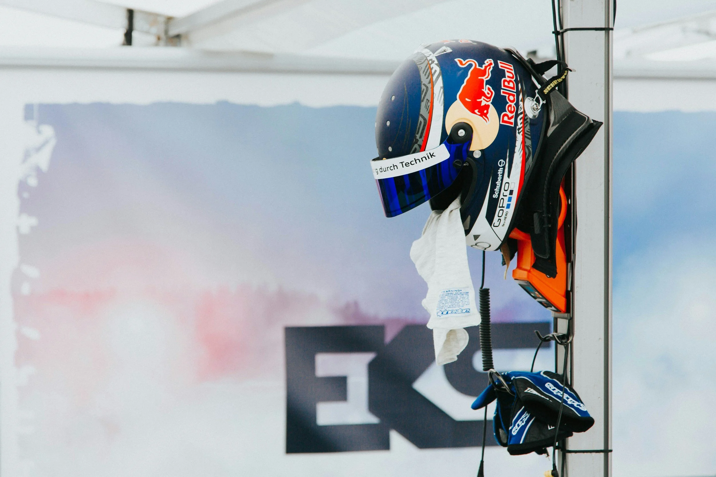 A professional racecar driver competing for red bull just hung up his helmet
