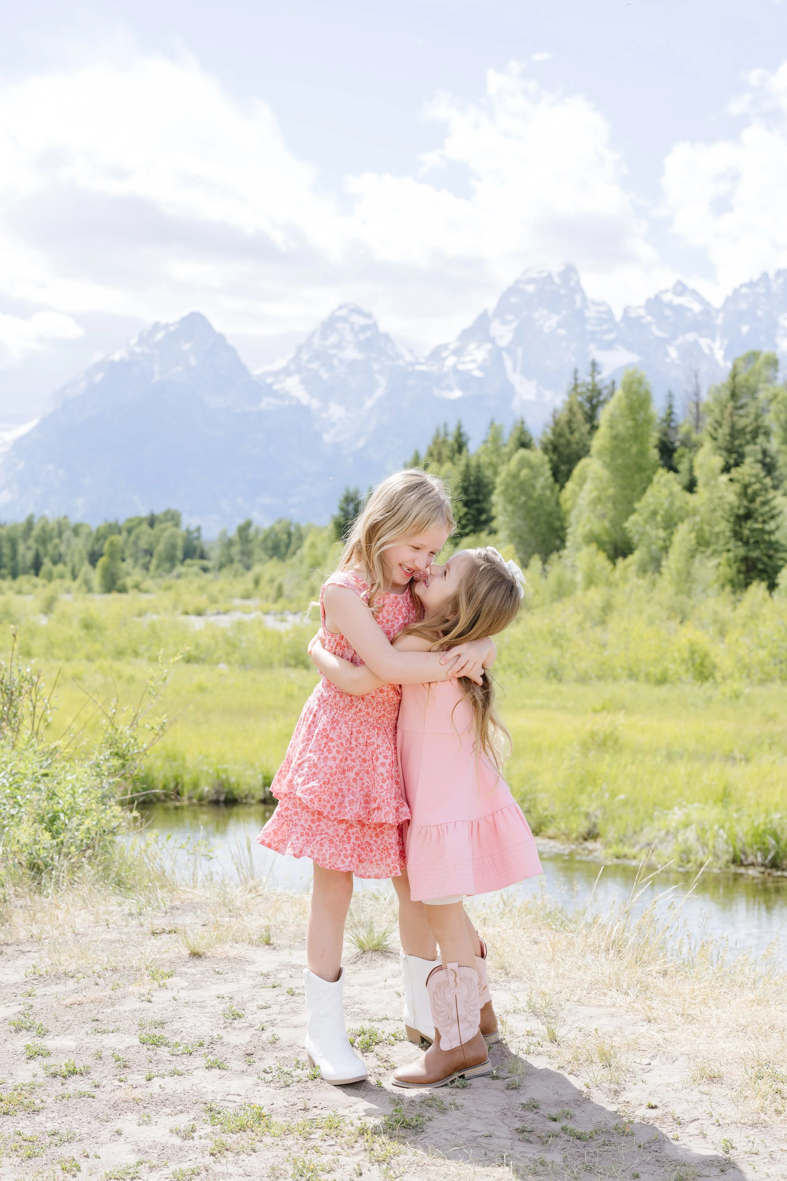 two sisters laughing during a sunny photo shoot in the mountains - Why Photography Matters