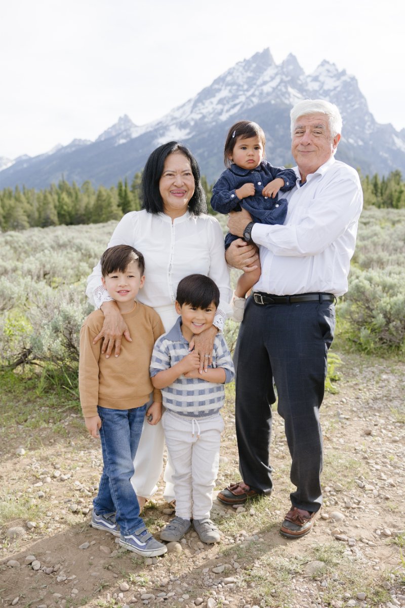  Grandparents posing with grandchildren in front of Jackson Hole mountains.  
