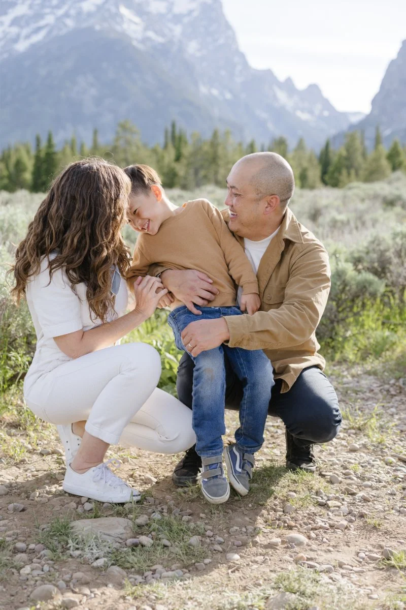  Photographer snaps picture of family with young boy as she shares tips for family photos with young kids in the mountains.  