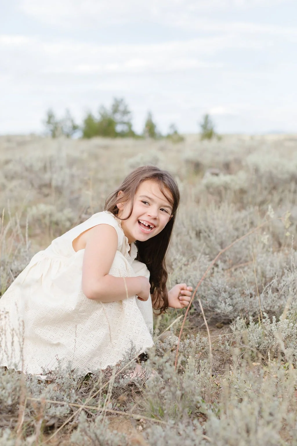  Young girl photographed smiling as her photographer shares things to do in Jackson Hole with young kids. 