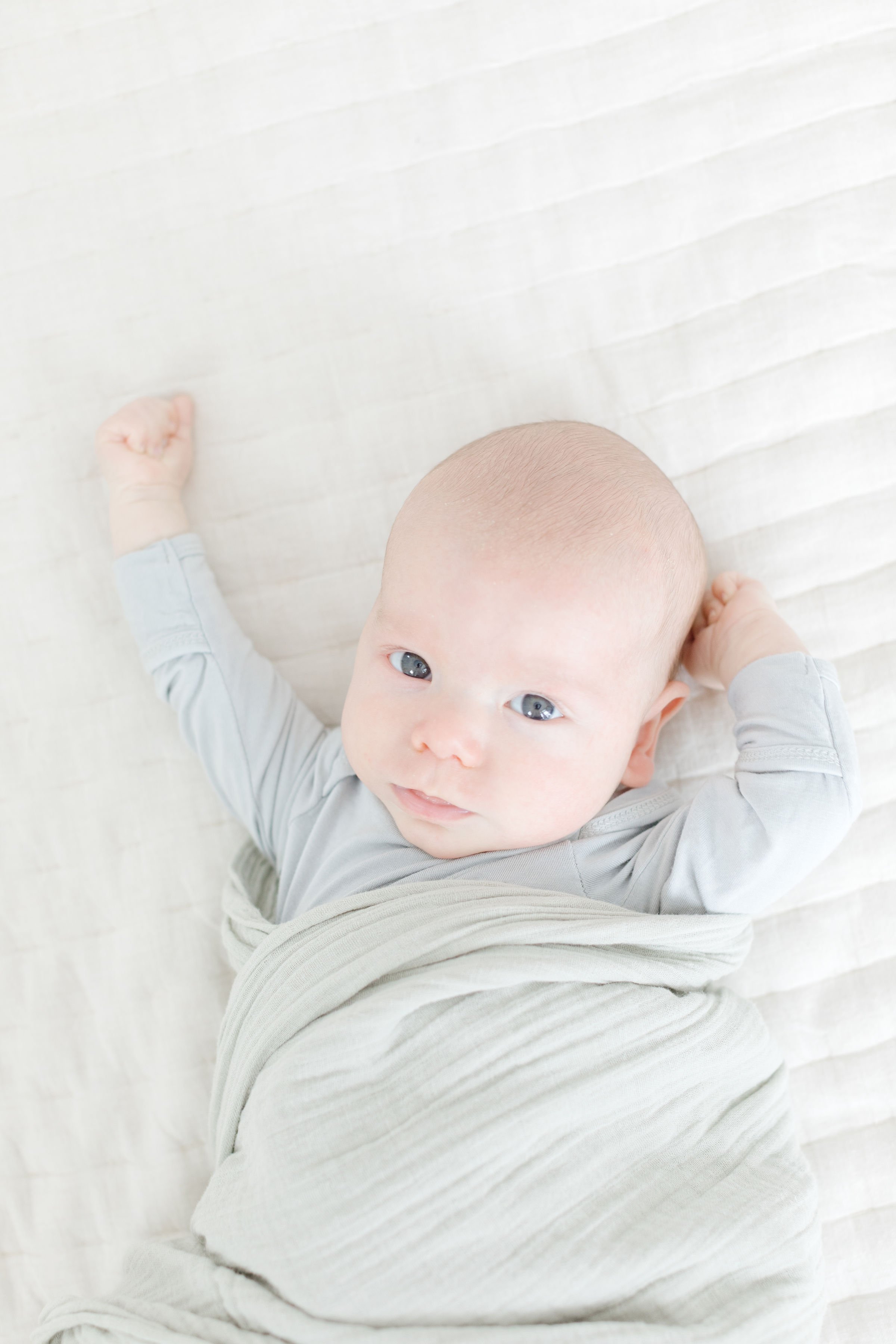  Newborn stretching out of swaddle 