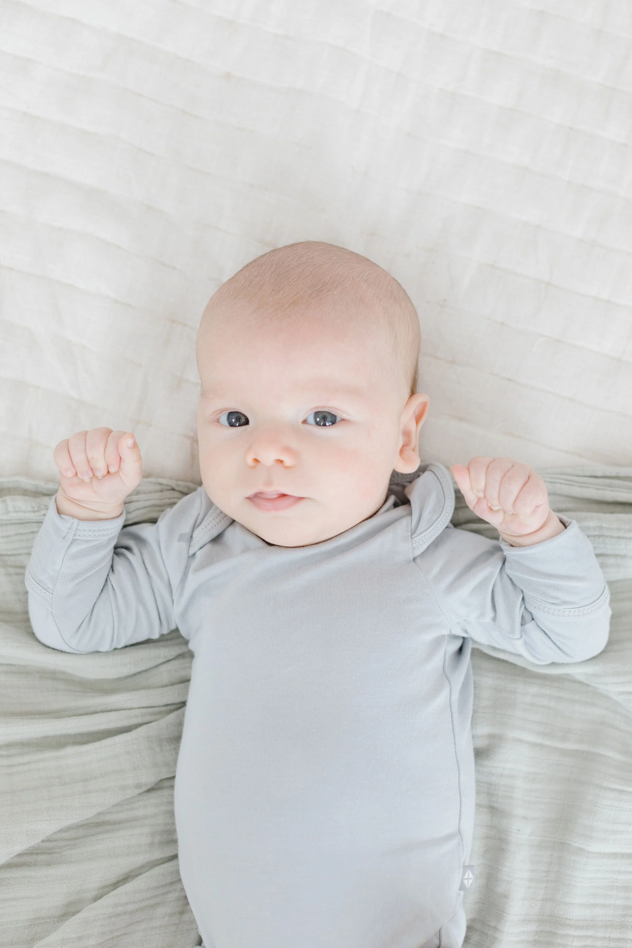  Newborn laying on bed.  