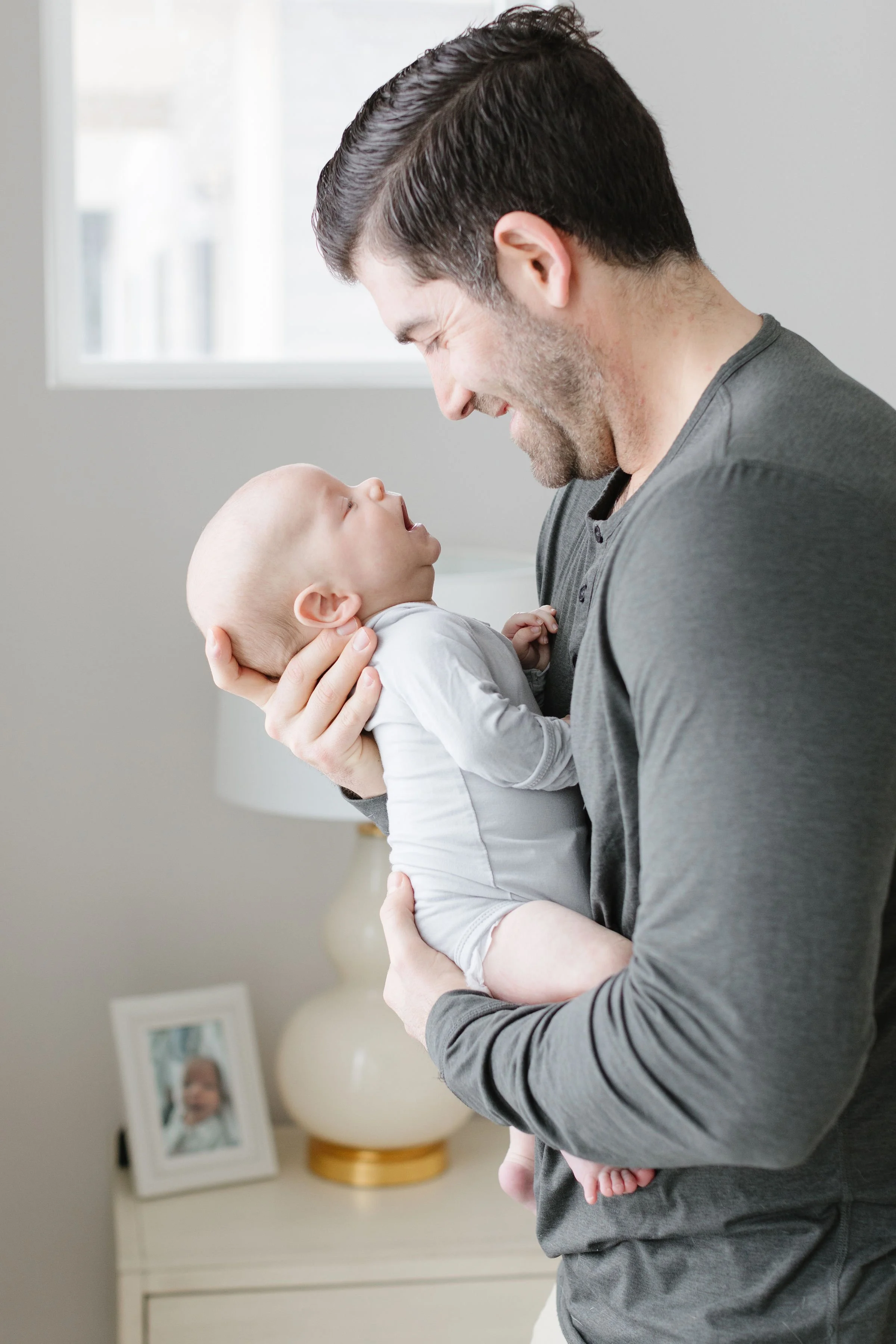  Dad holds baby boy as newborn photographer in Jackson Hole captures them.  