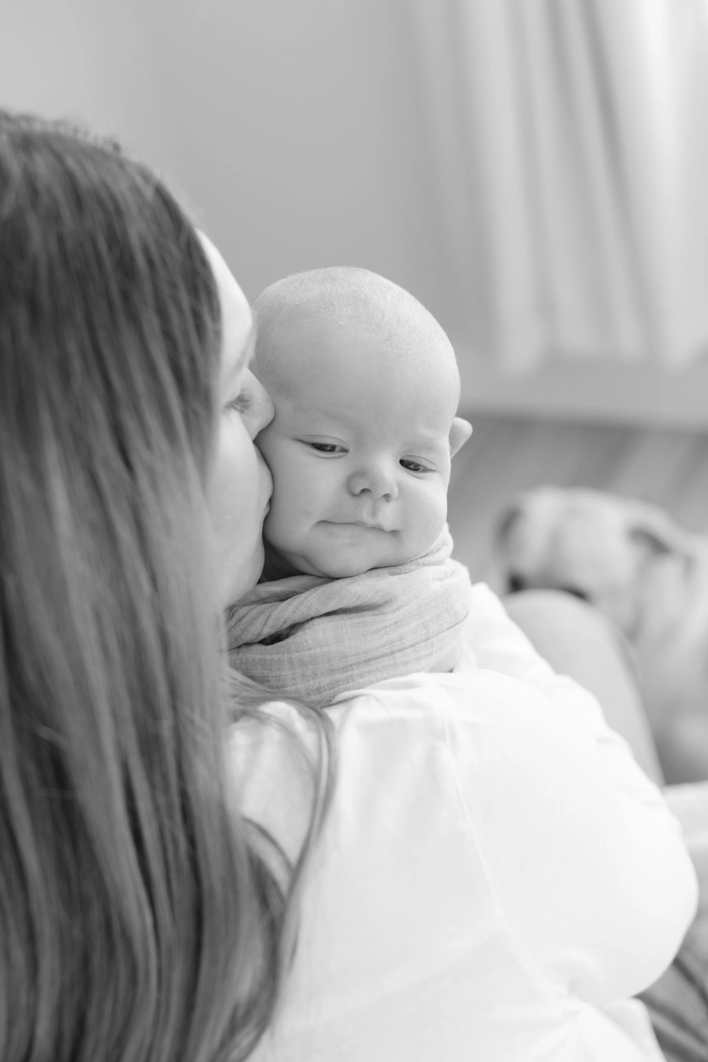  Mom holds newborn boy close to her 