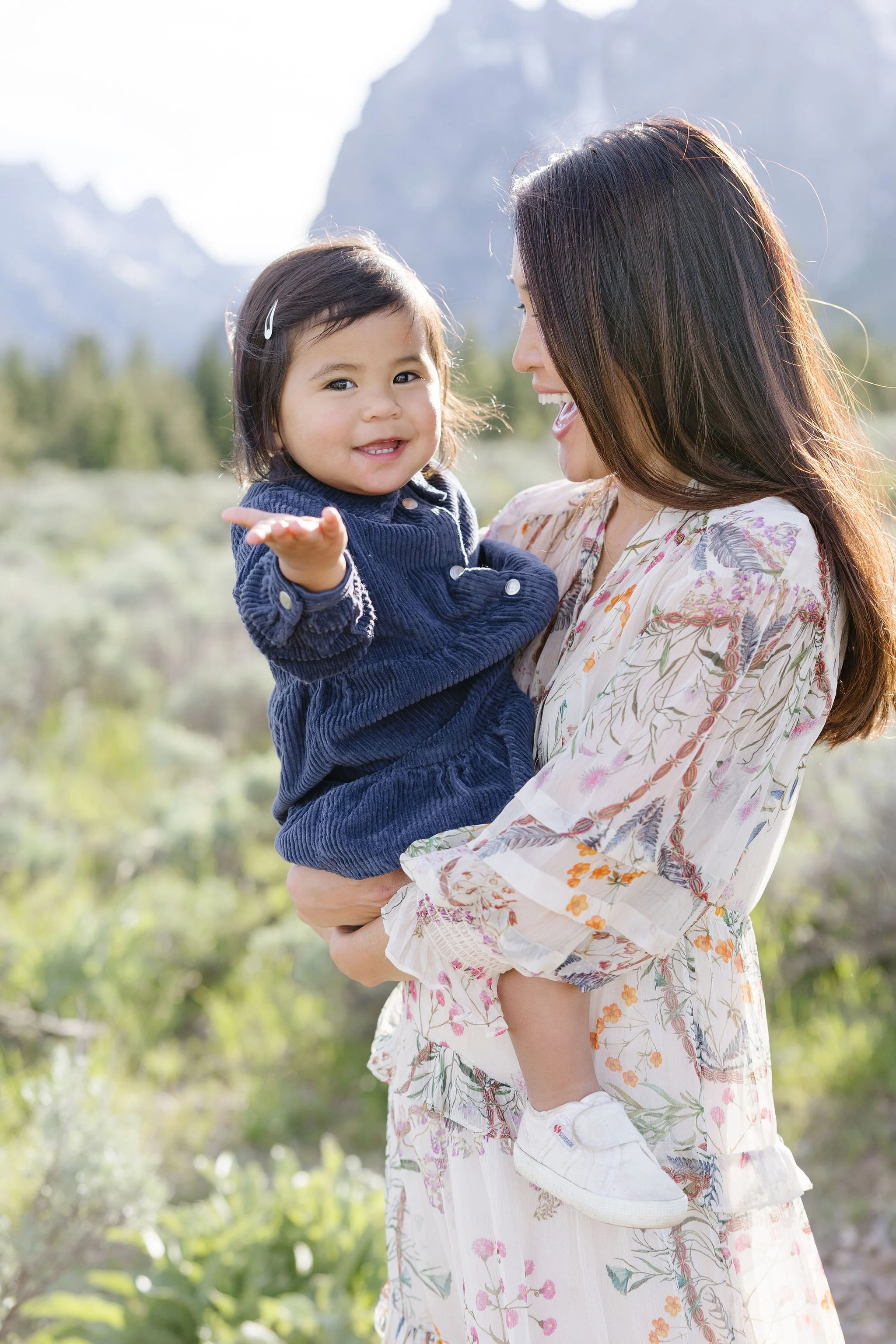  Mother holds daughter for photo in the Grand Tetons. 
