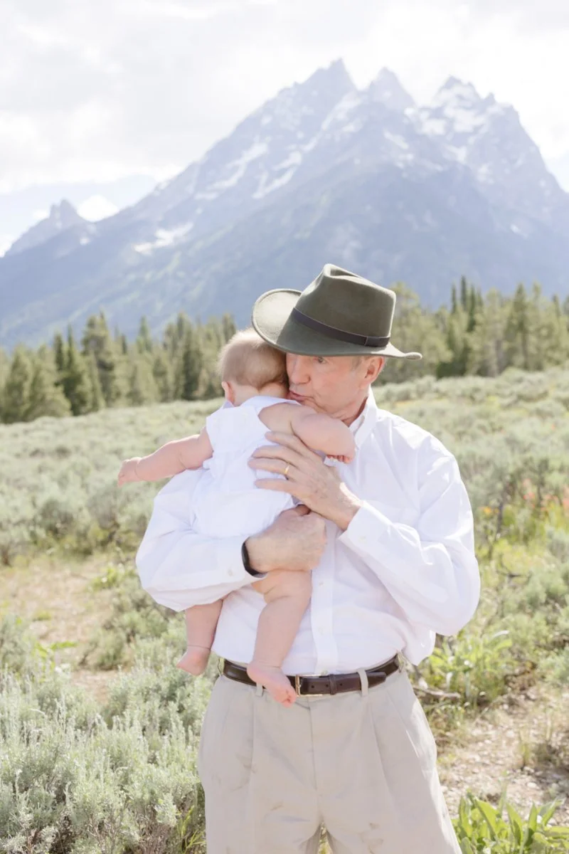  Photographer captures candid moment between grandfather and baby in Jackson Hole. 