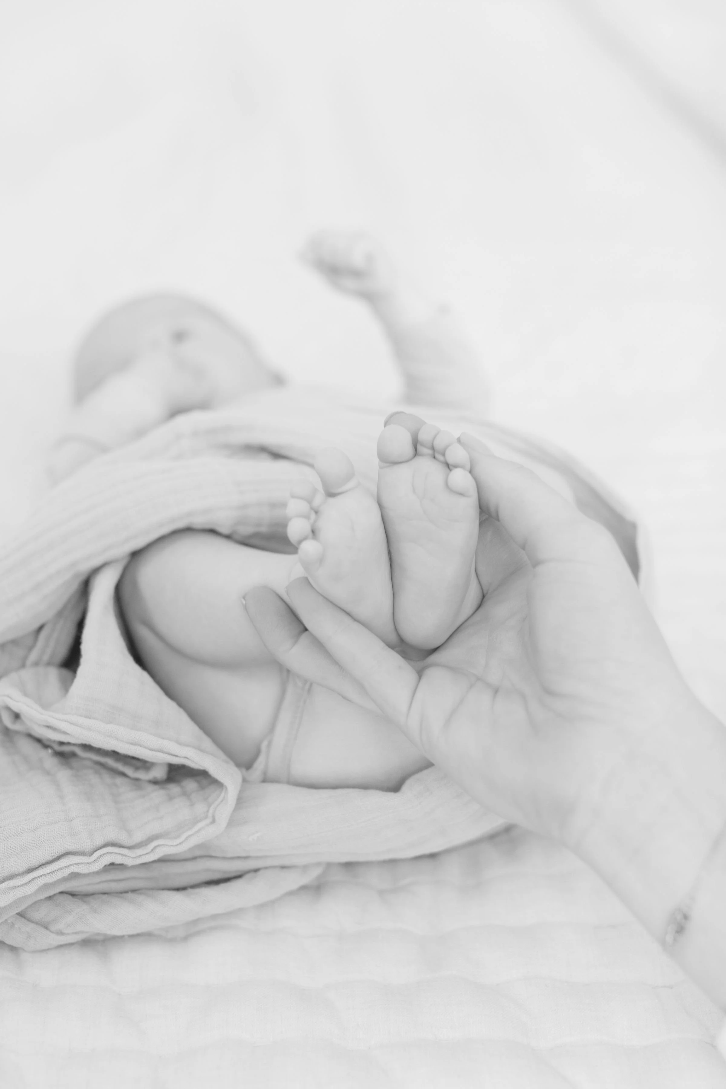  New parents are captured by lifestyle photographer in Jackson Hole during family newborn pictures at home. 