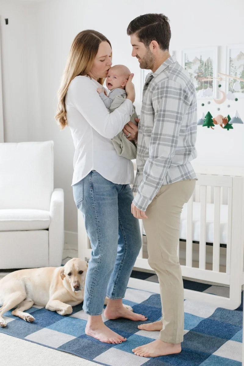  Mother soothes baby during newborn photoshoot. 