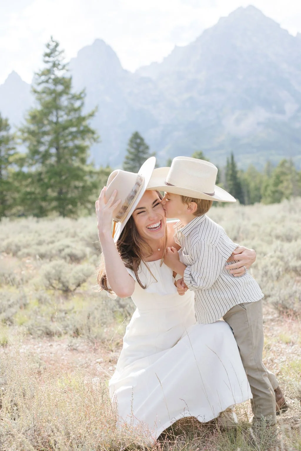  Little boy kisses mom on the cheek during western family photos in Jackson Hole. 
