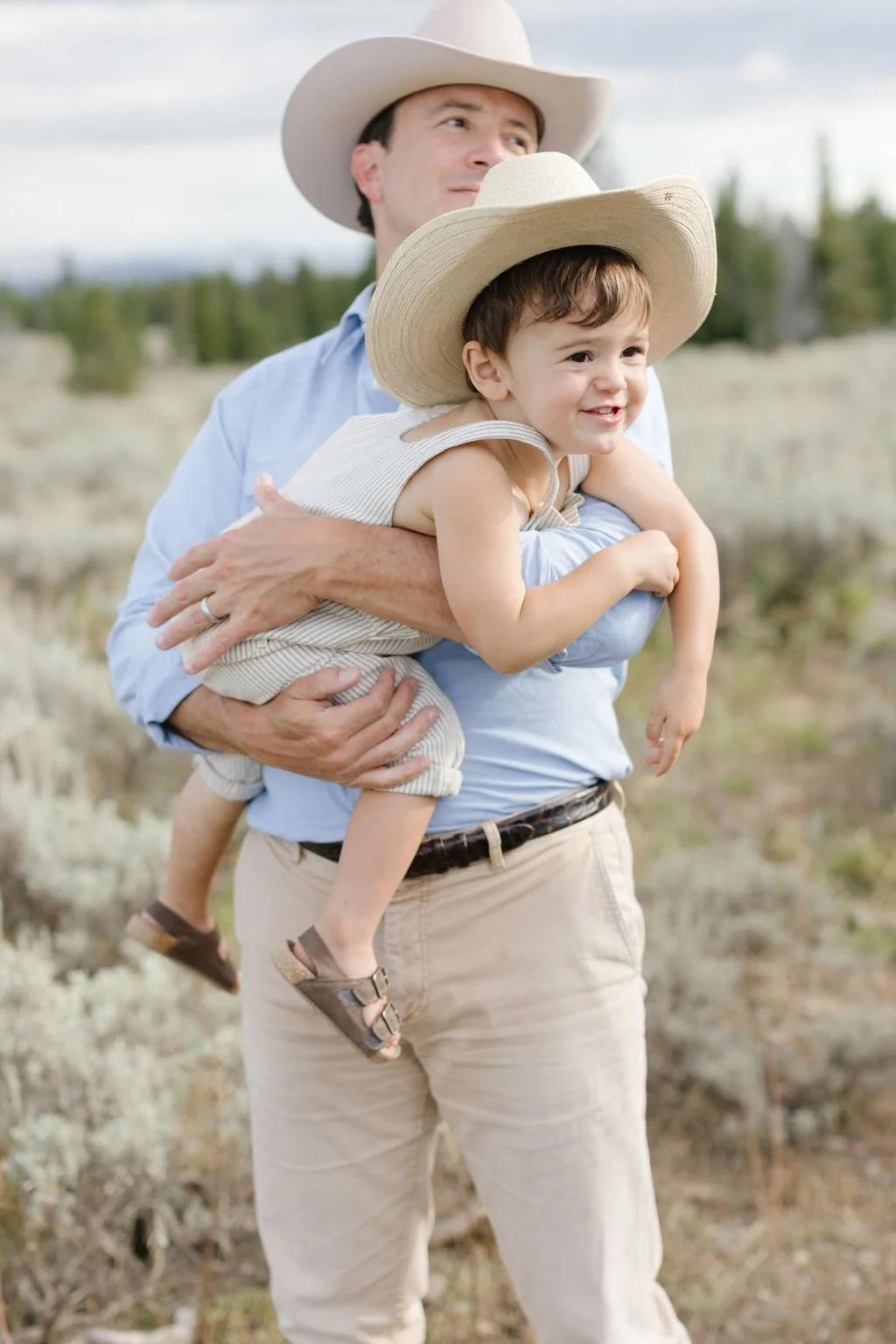  Dad holds little boy during western family photos in Jackson Hole. 