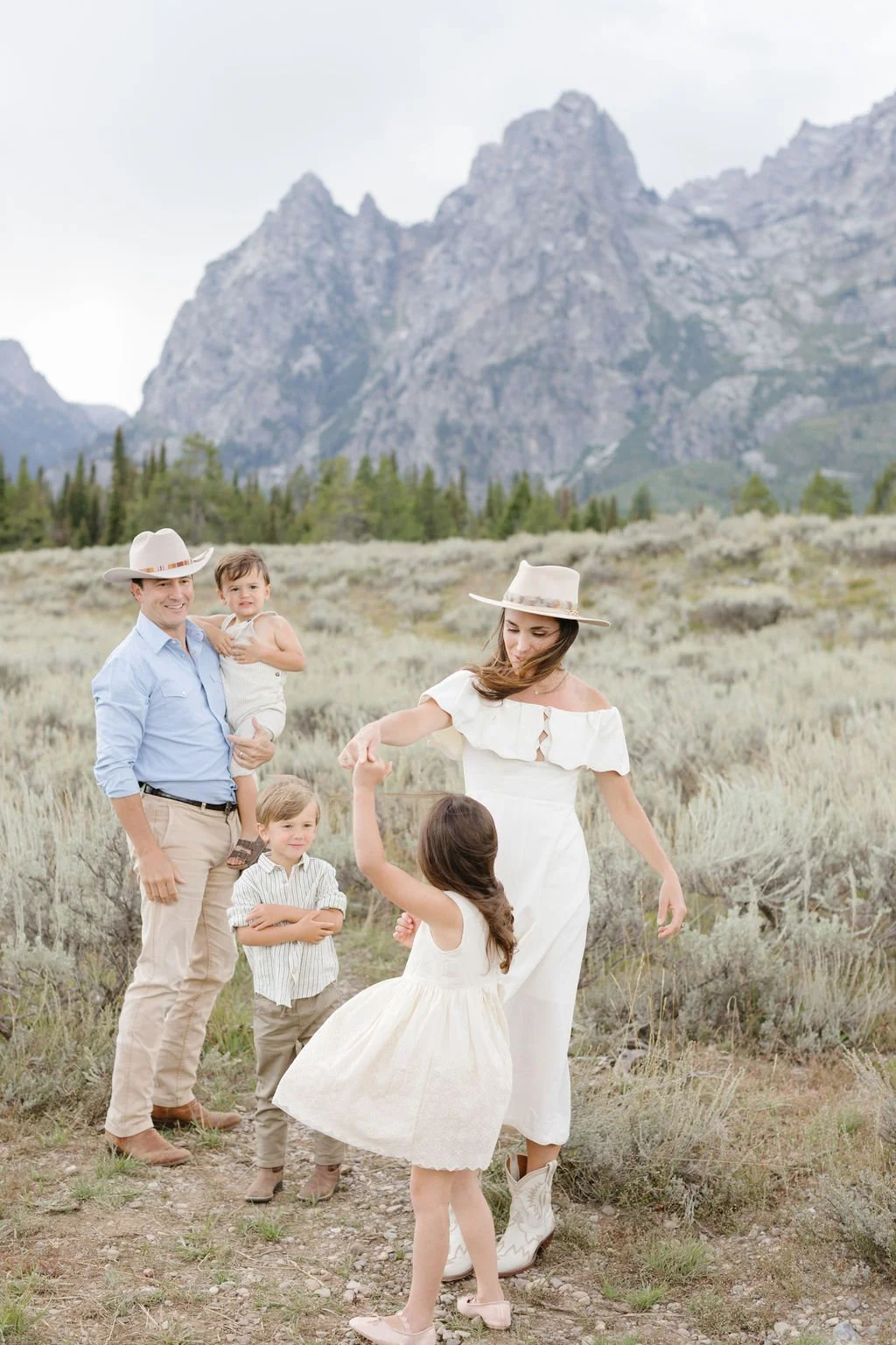  Mother spins daughter in dress during western family photos in Jackson Hole. 
