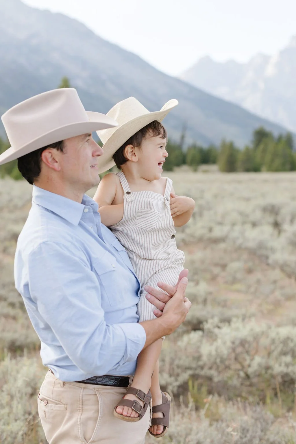  Dad holds son as he laughs during family photos in Jackson Hole. 