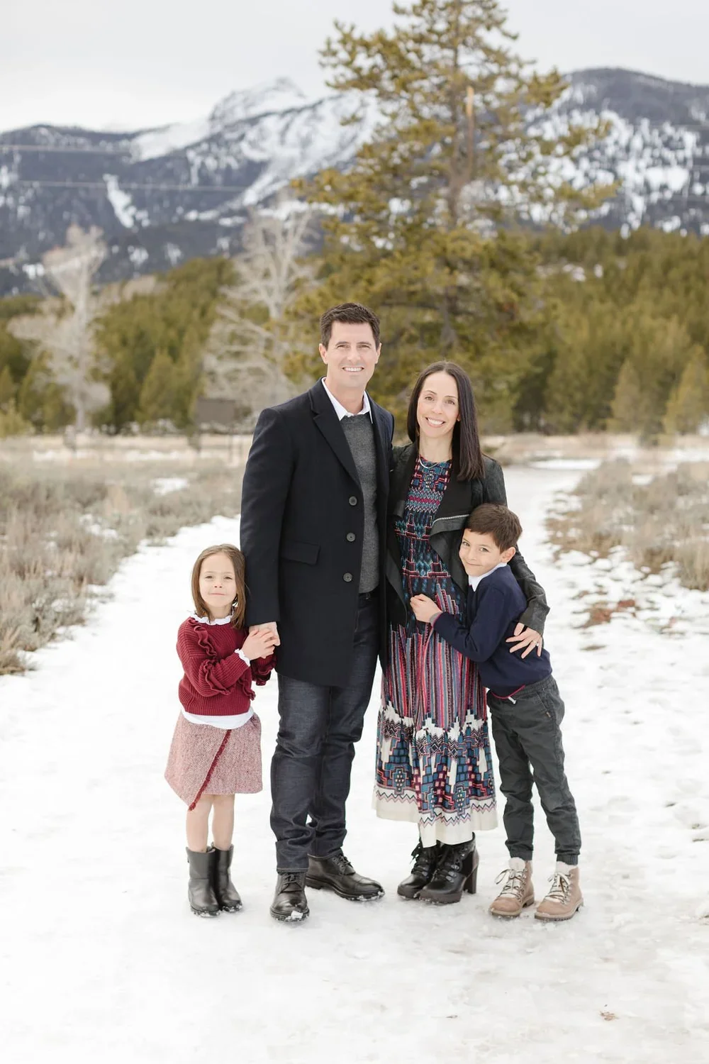 Family stands on a snow covered trail in Jackson Hole.