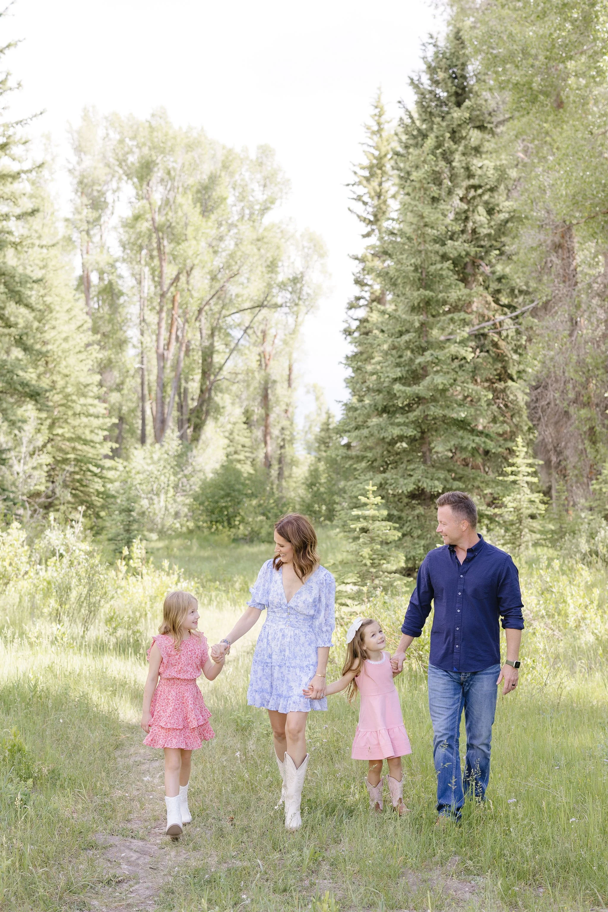  Family walks together hand in hand, proving family photo poses don’t have to be rigid. 