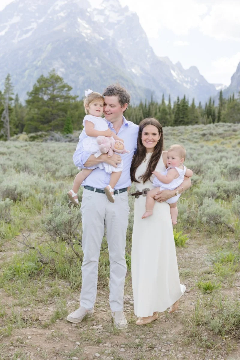  Family stand together as they pose for a photo along the legendary going-to-the-sun road Montana. 