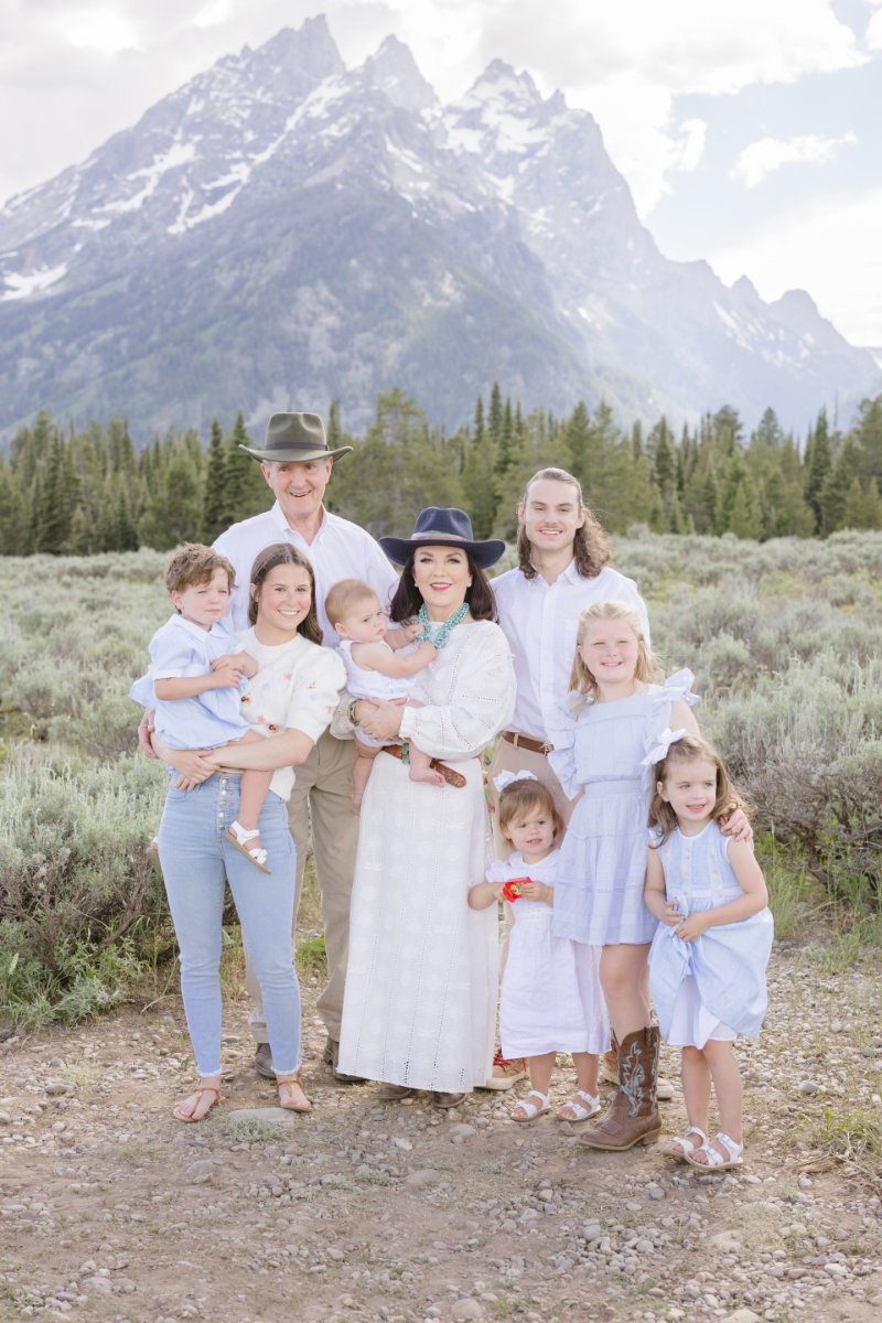  Grandparents and grand kids stand together for photo. 