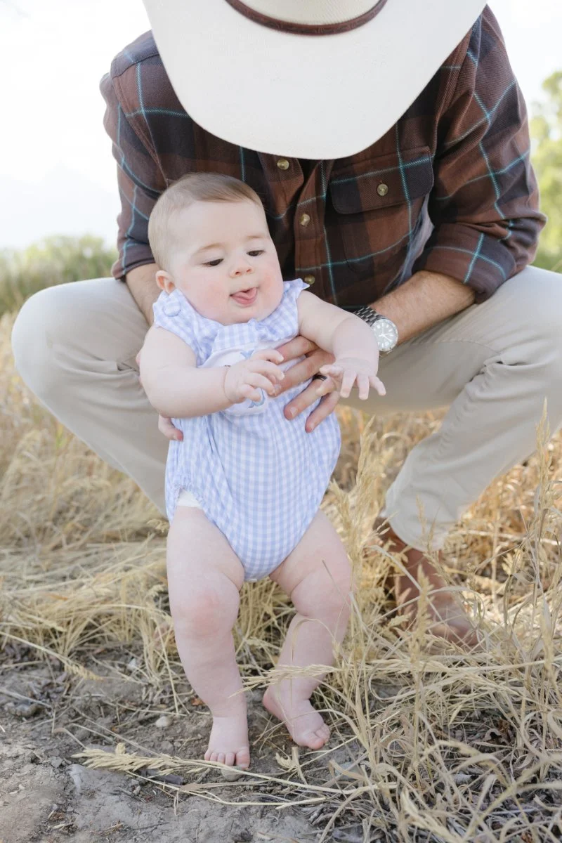  Baby exploring the outdoors while traveling with babies in Grand Teton National Park during a family vacation. 