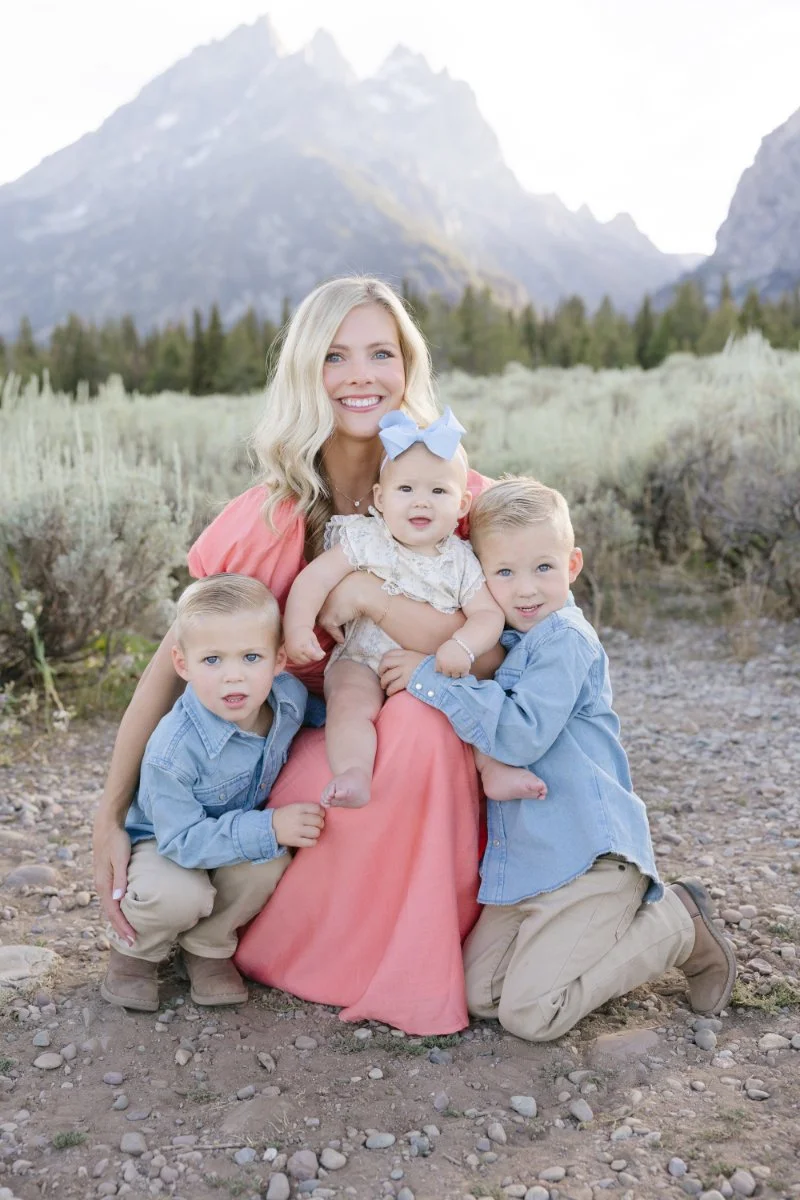  Mom holding her children during a family session while traveling with babies in Grand Teton National Park. 