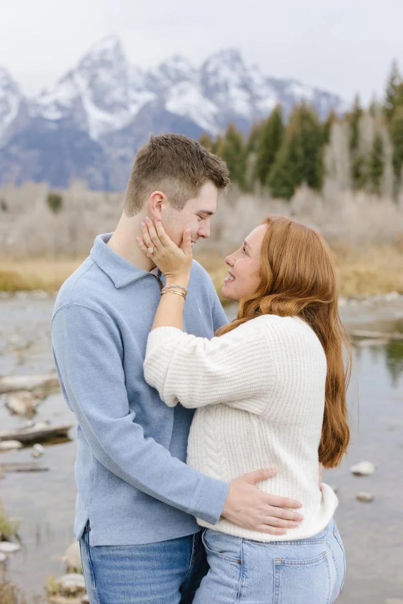  Emotional moment during a Grand Teton proposal as the newly engaged couple celebrates by the river 