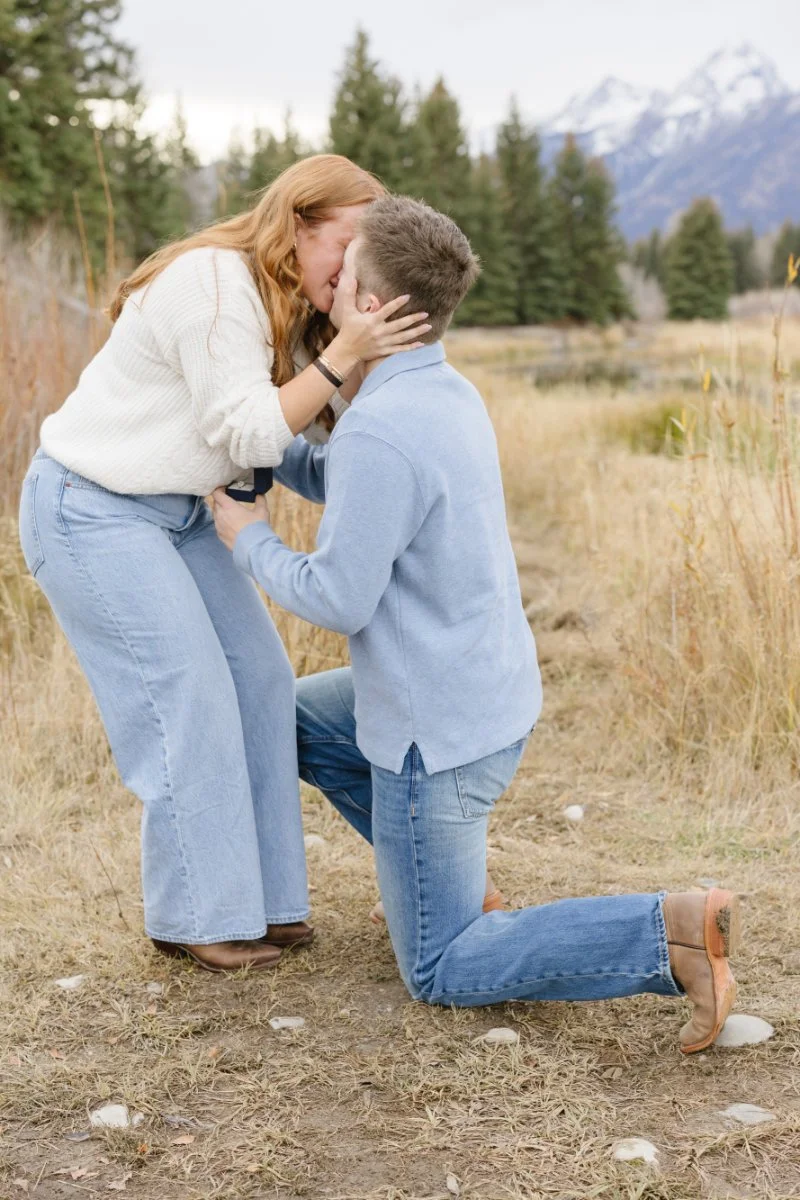  Couple sharing their first kiss after a successful Grand Teton proposal in Wyoming 